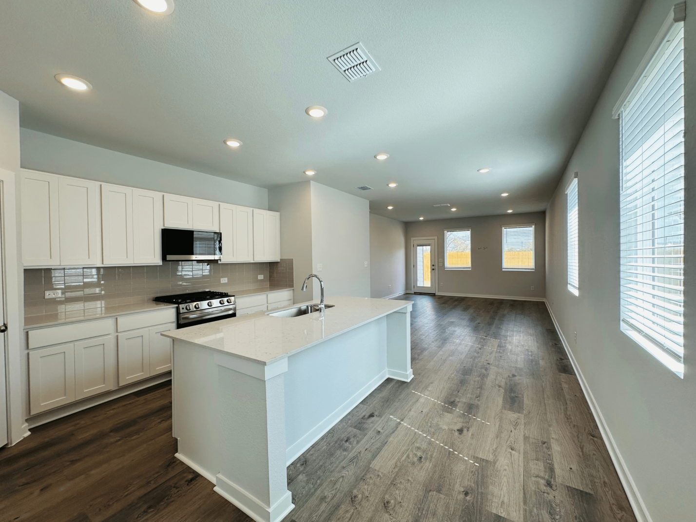 A kitchen with white cabinets.