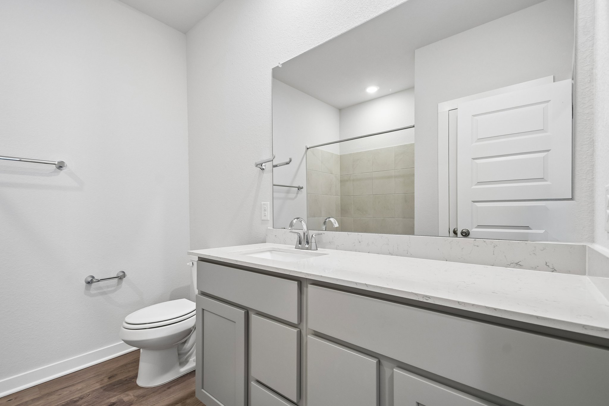 A bathroom with a large mirror.