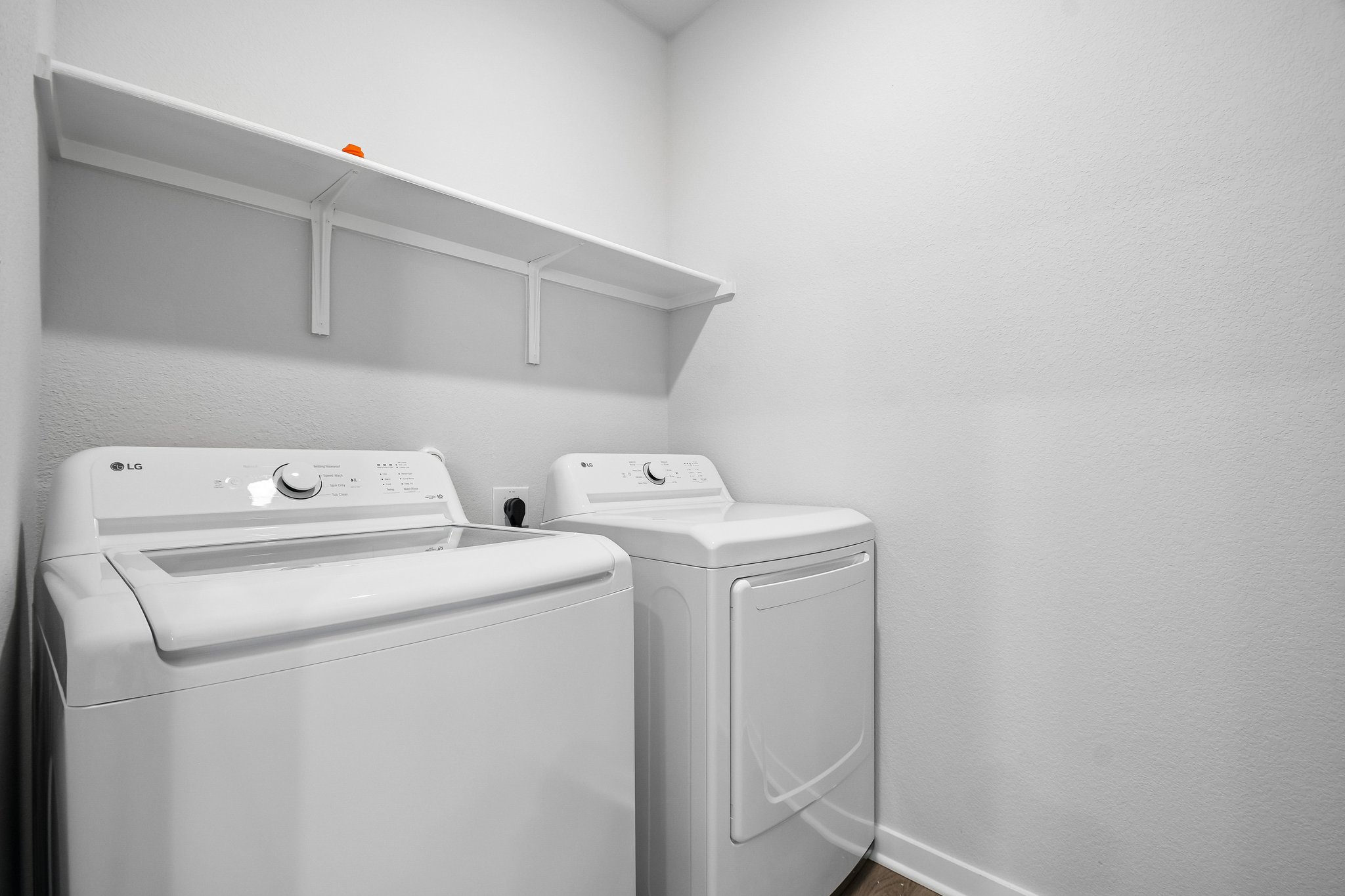 A washing machine and dryer in a room.