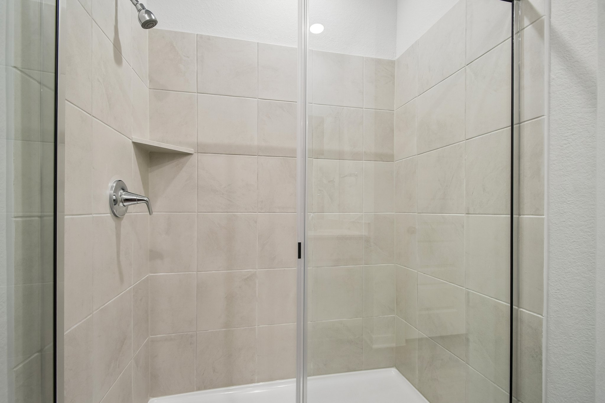 A shower with a glass door.