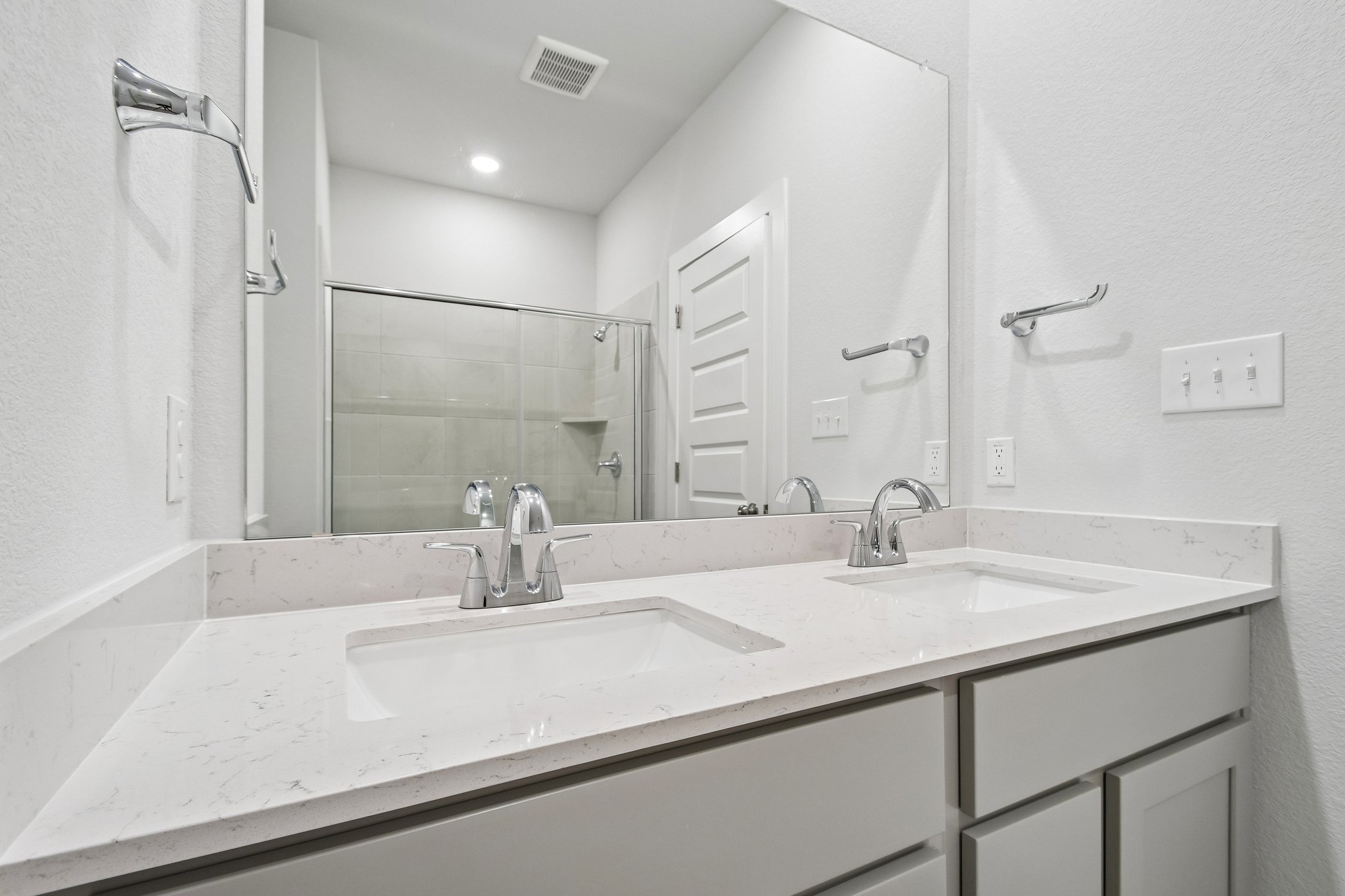 A bathroom with a large mirror.