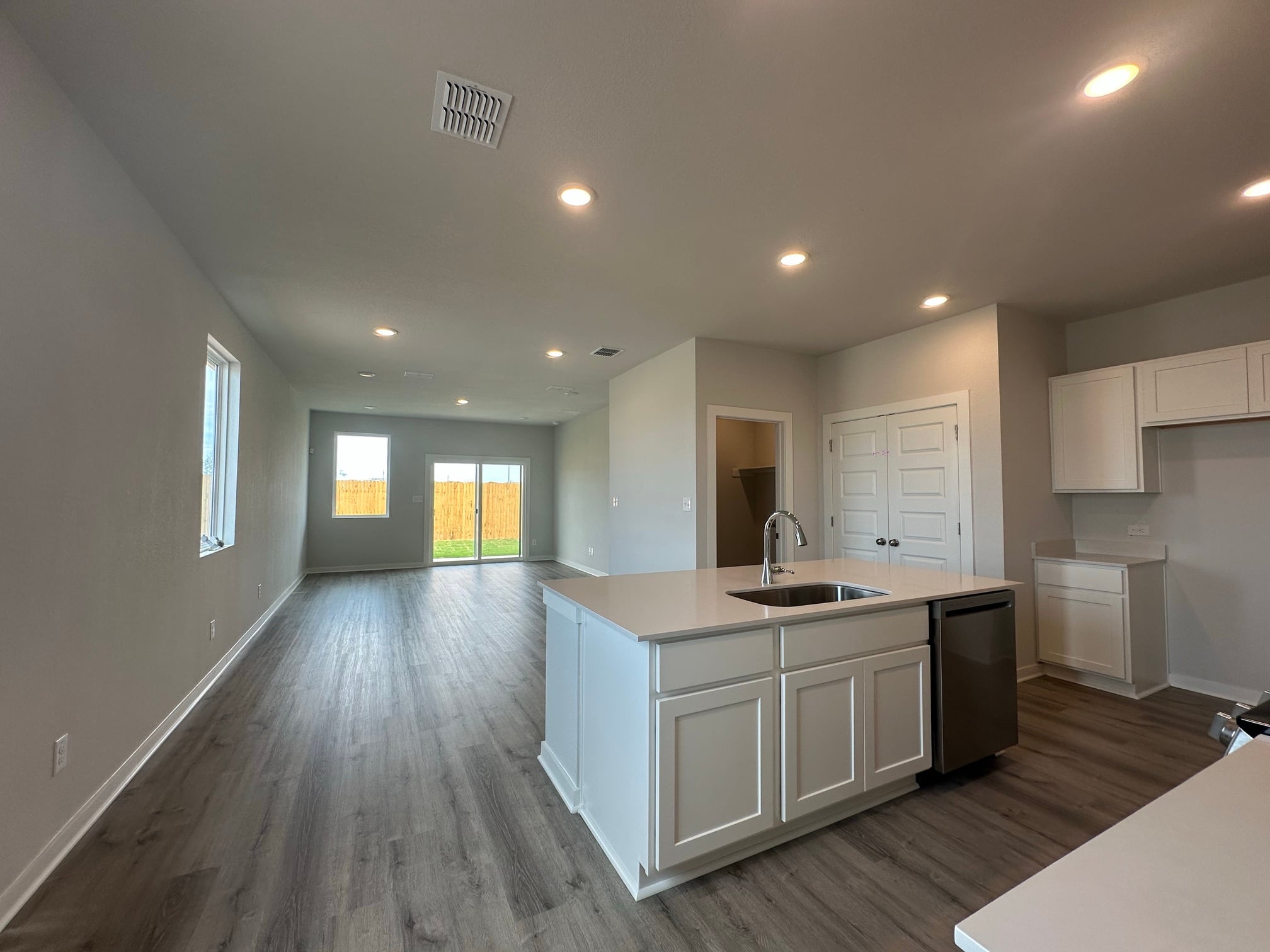 A kitchen with white cabinets.