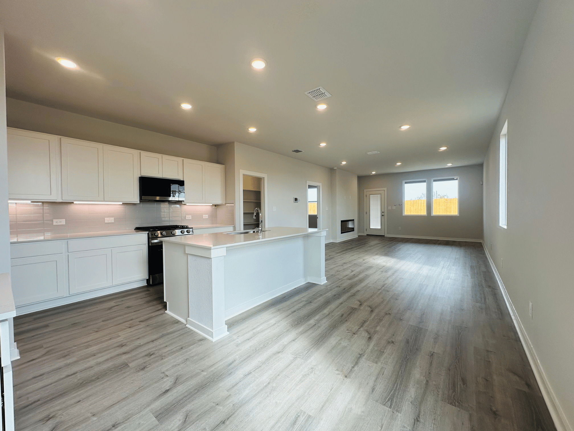 A large kitchen with white cabinets.
