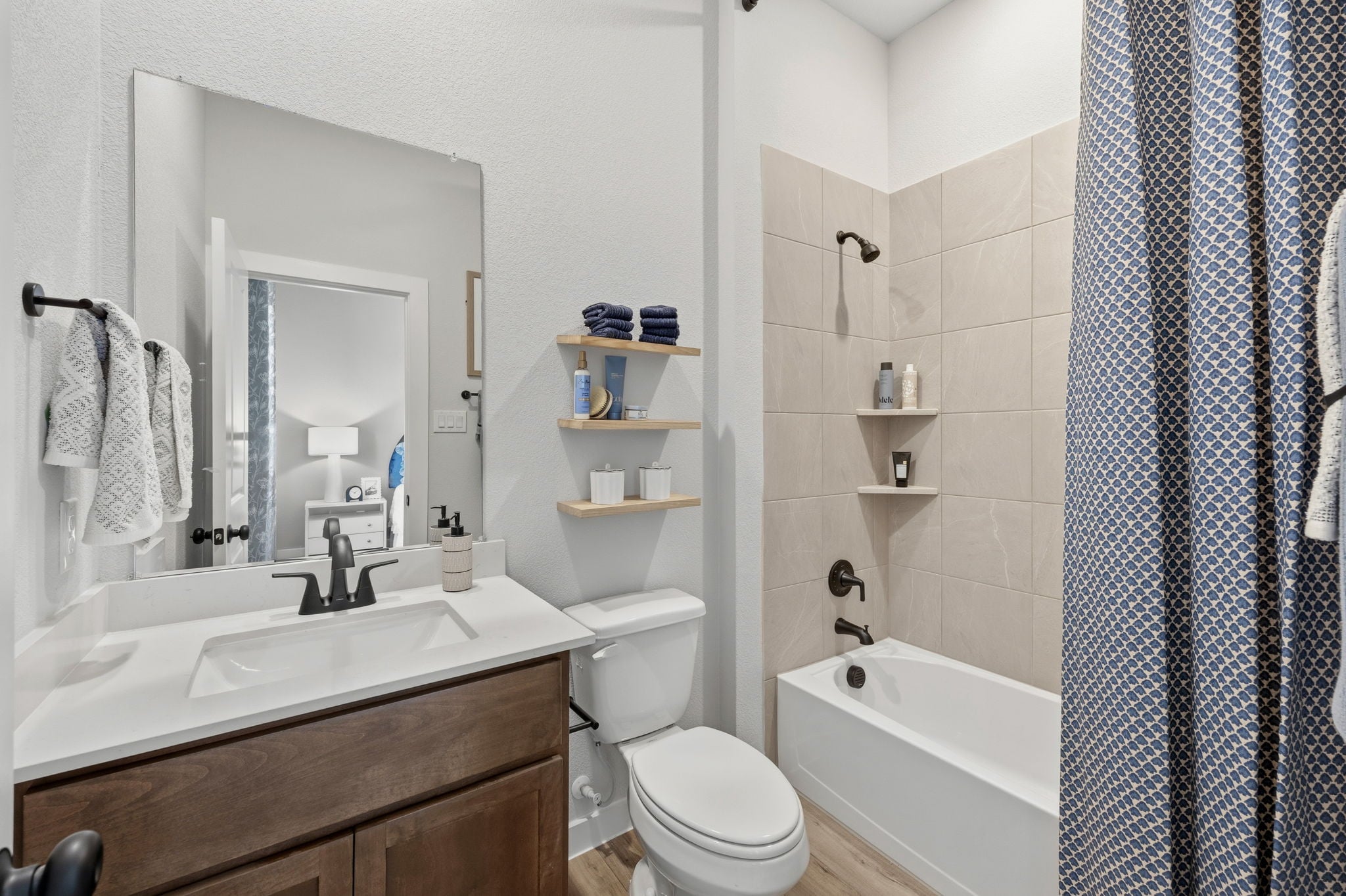 A bathroom with a tub toilet and sink.