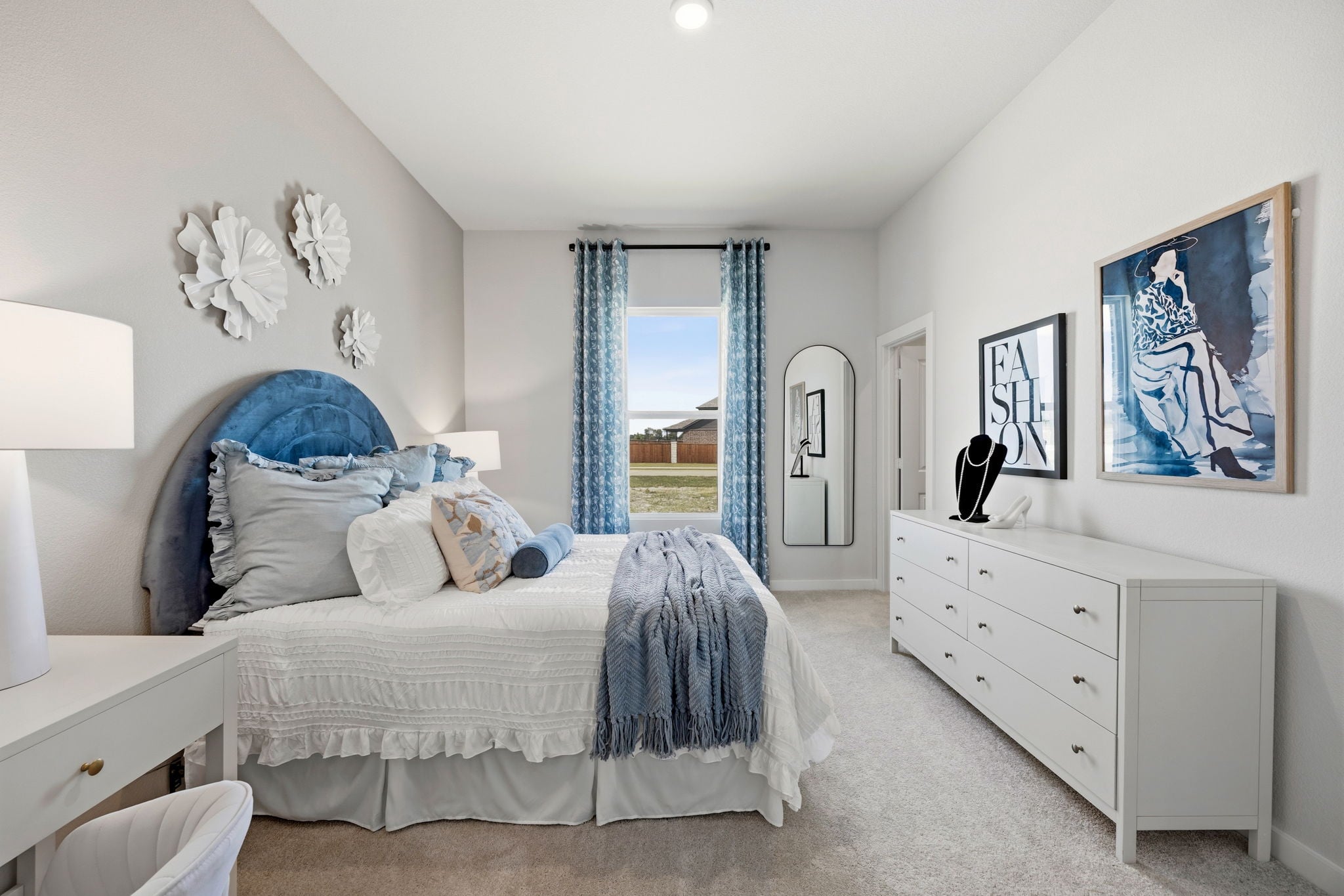 A bedroom with a large window.