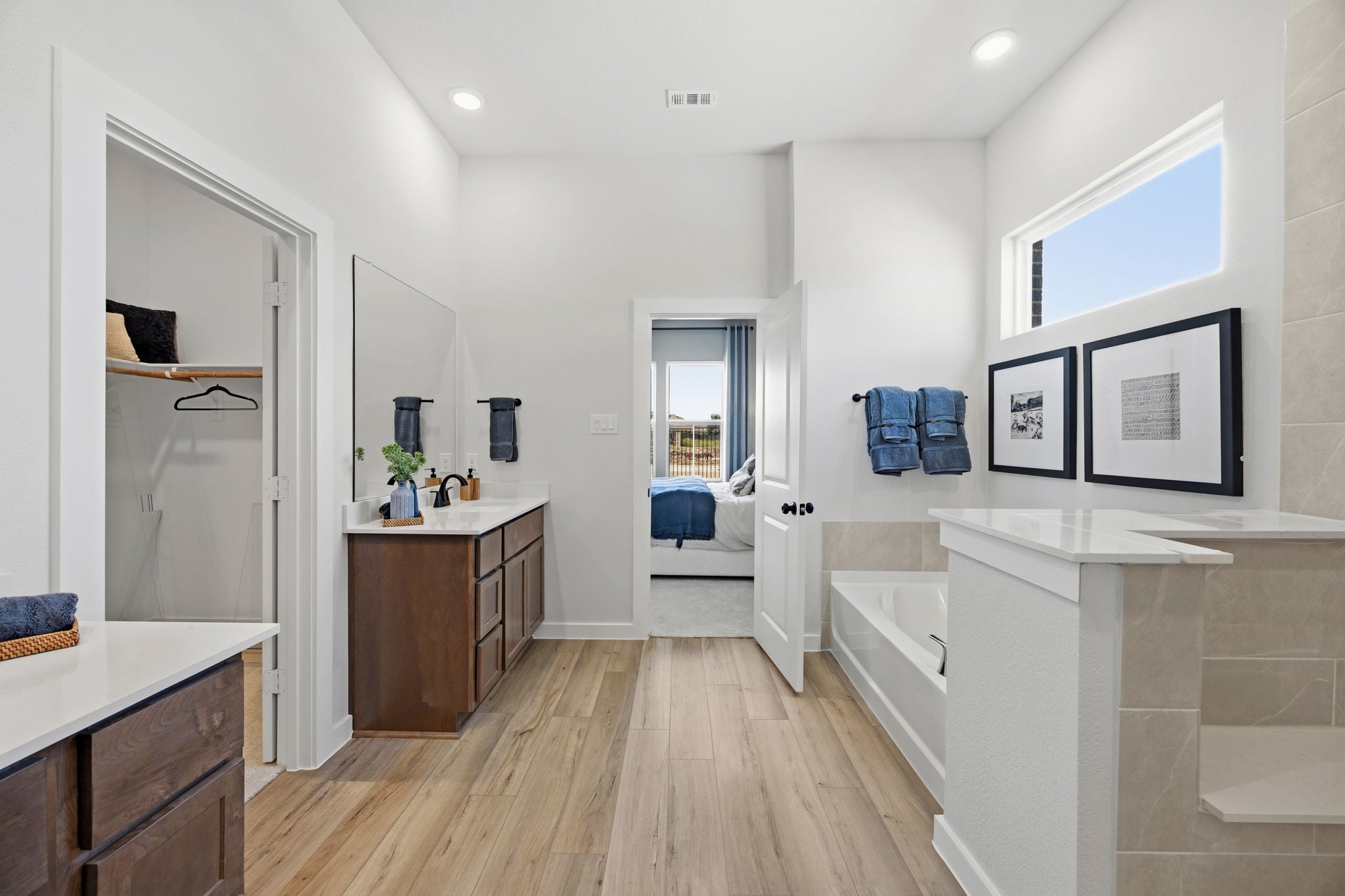 A bathroom with a tub sink and a toilet.