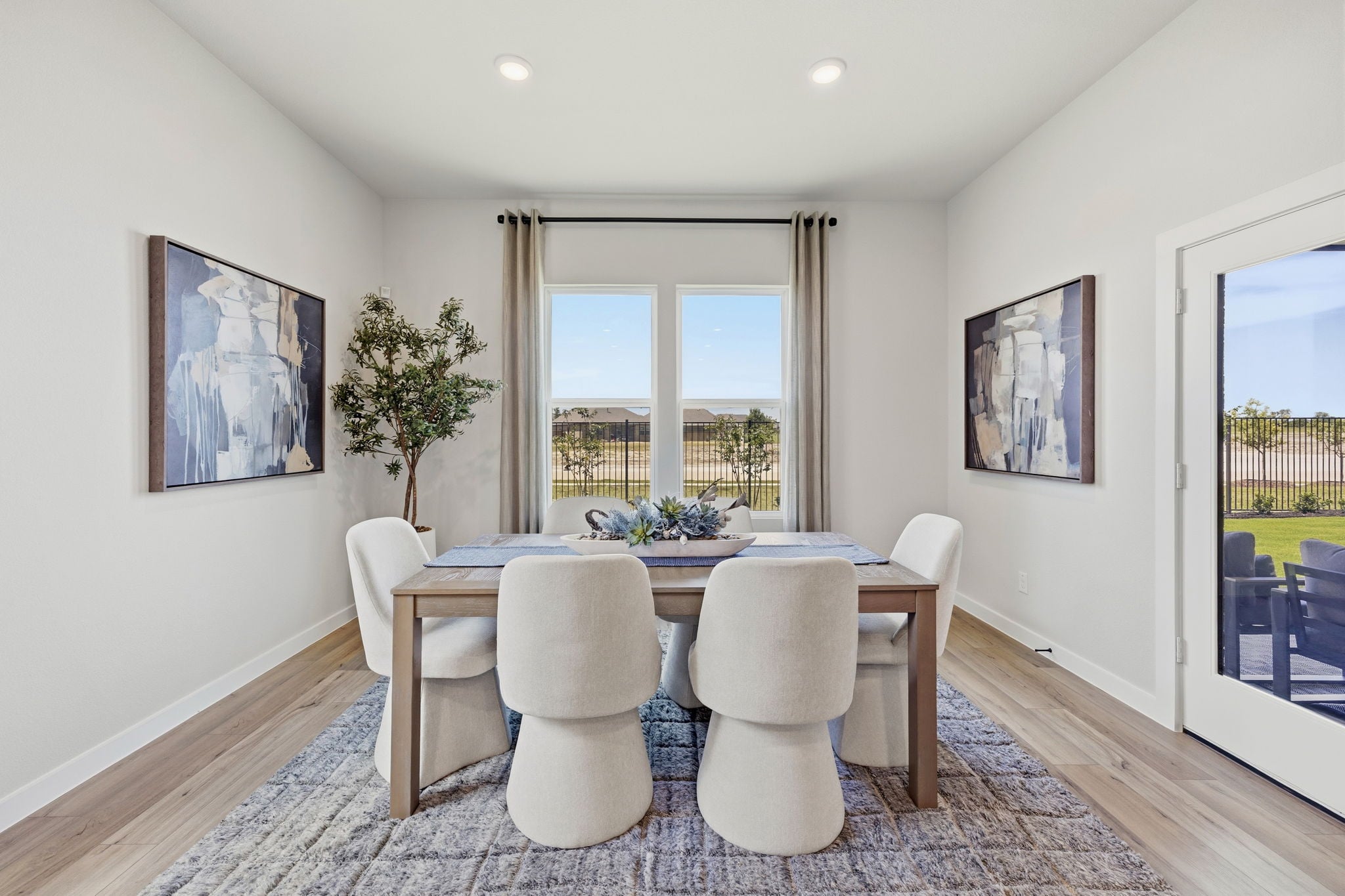 A dining room with a large table.