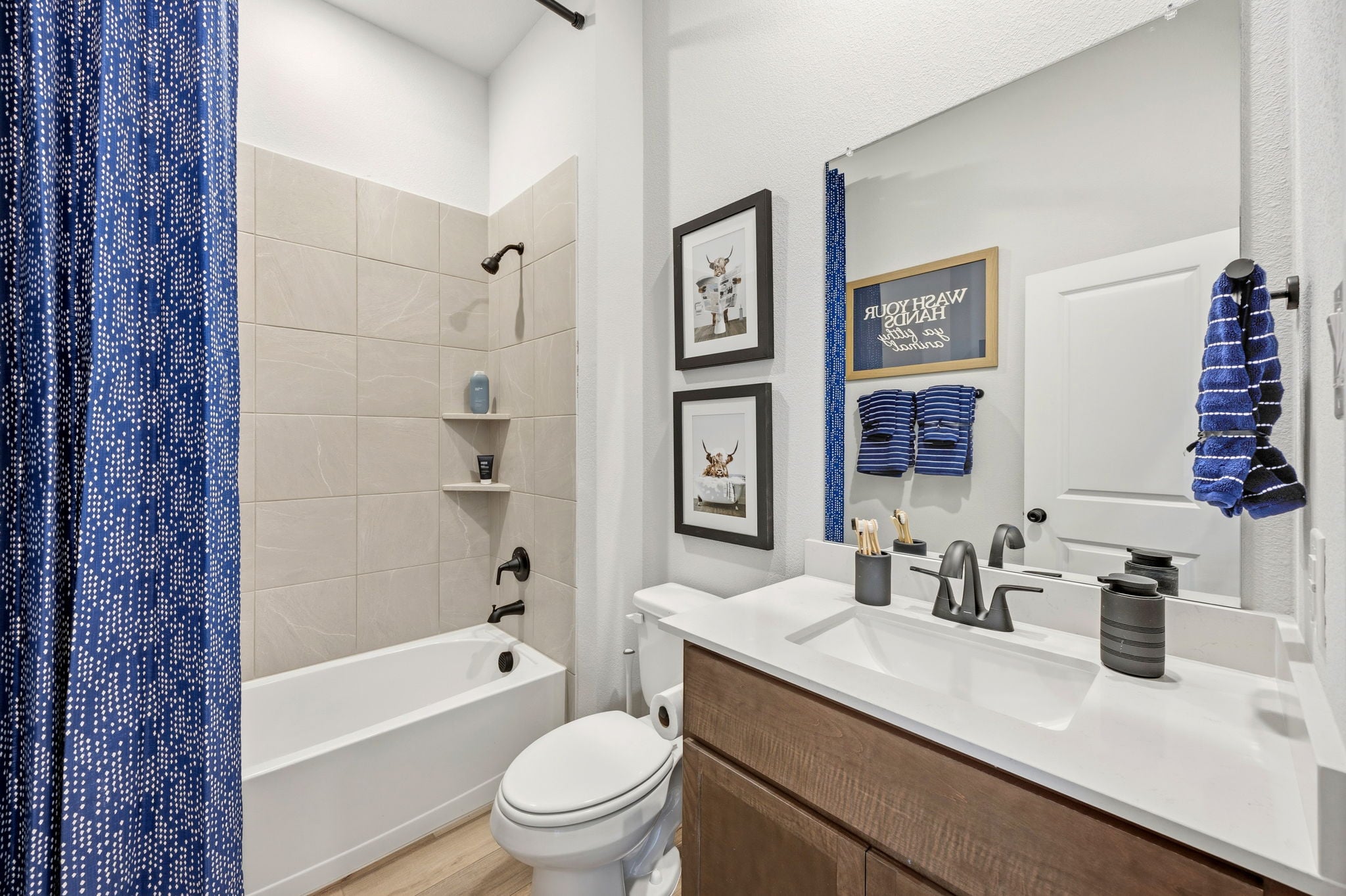 A bathroom with a tub sink and toilet.