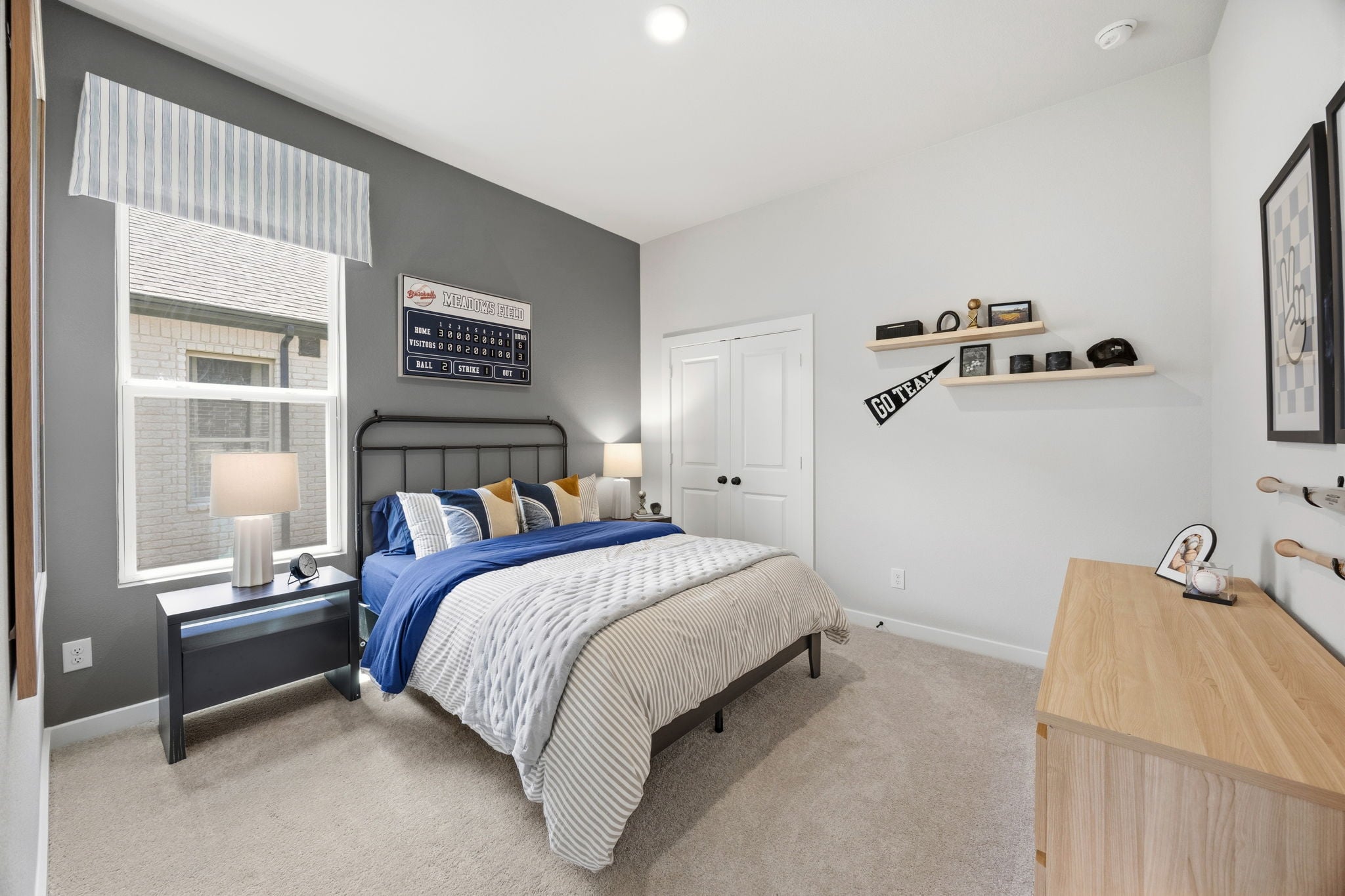 A bedroom with a bed and a desk.