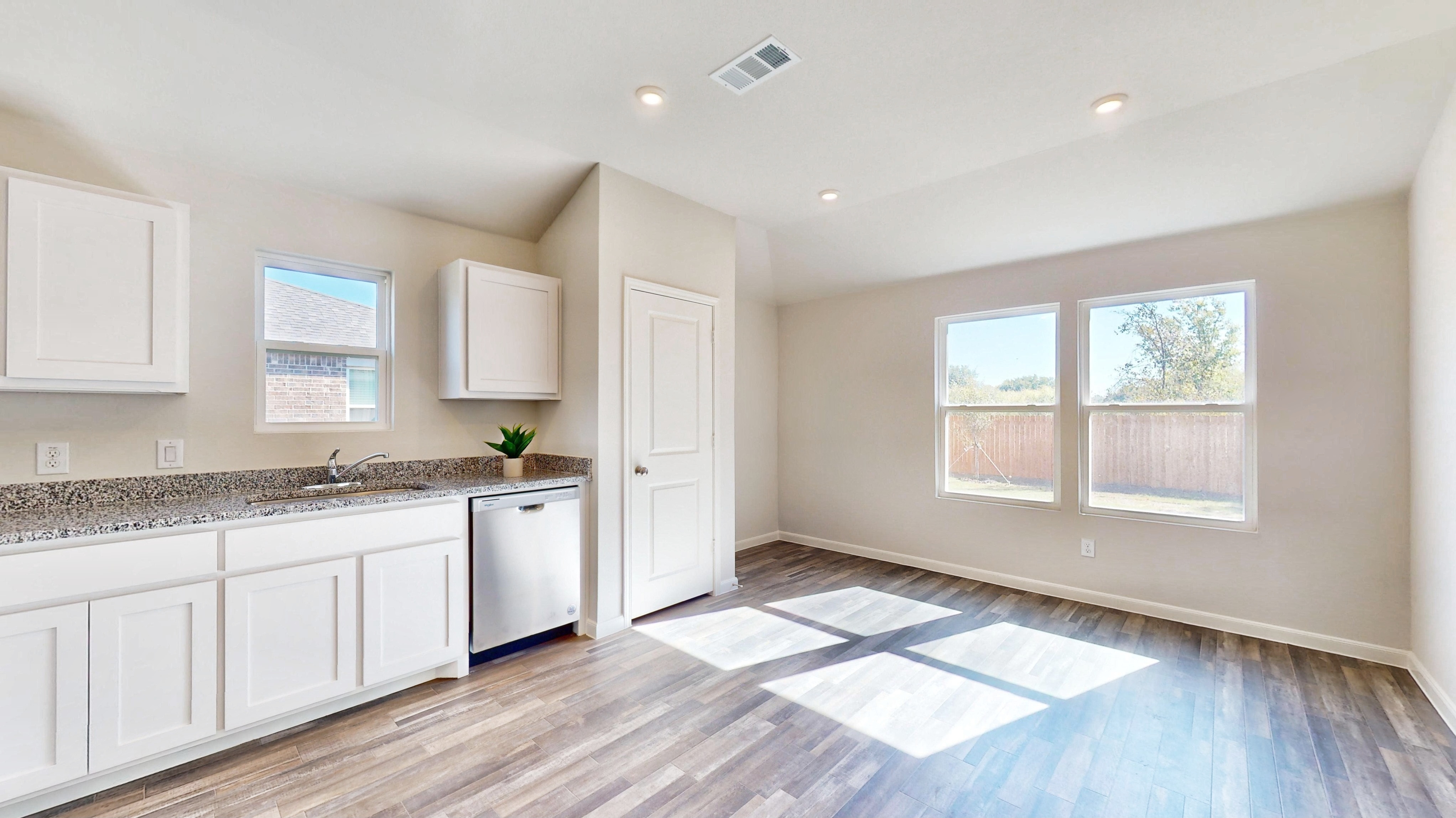 A kitchen with white cabinets.