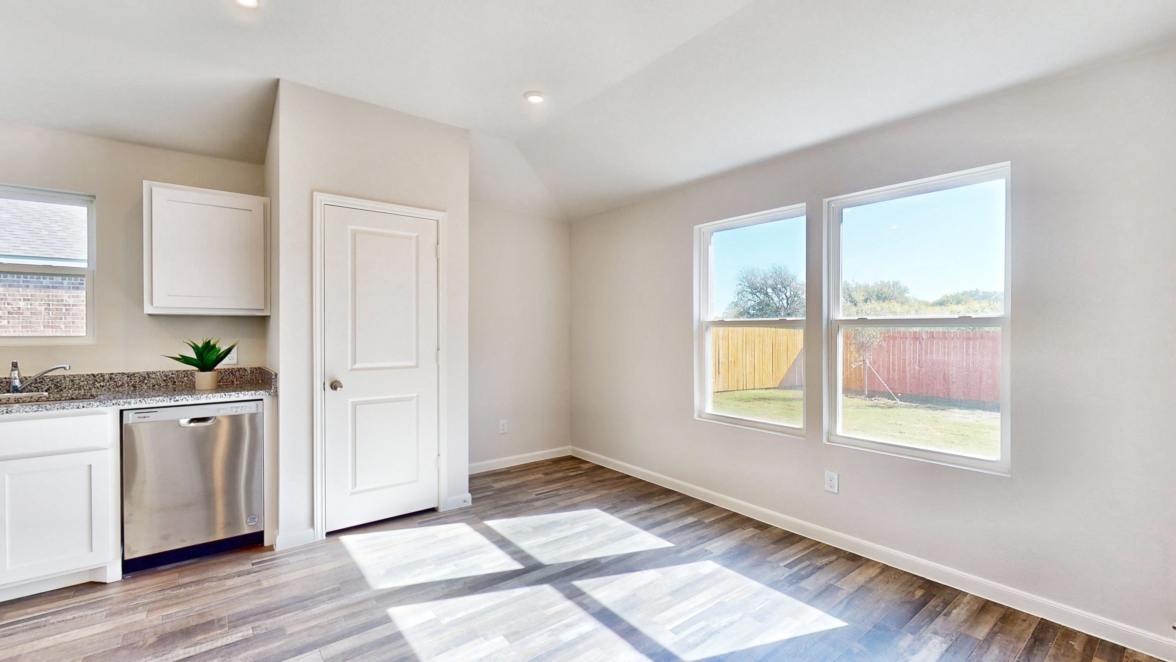 A kitchen with a large window.