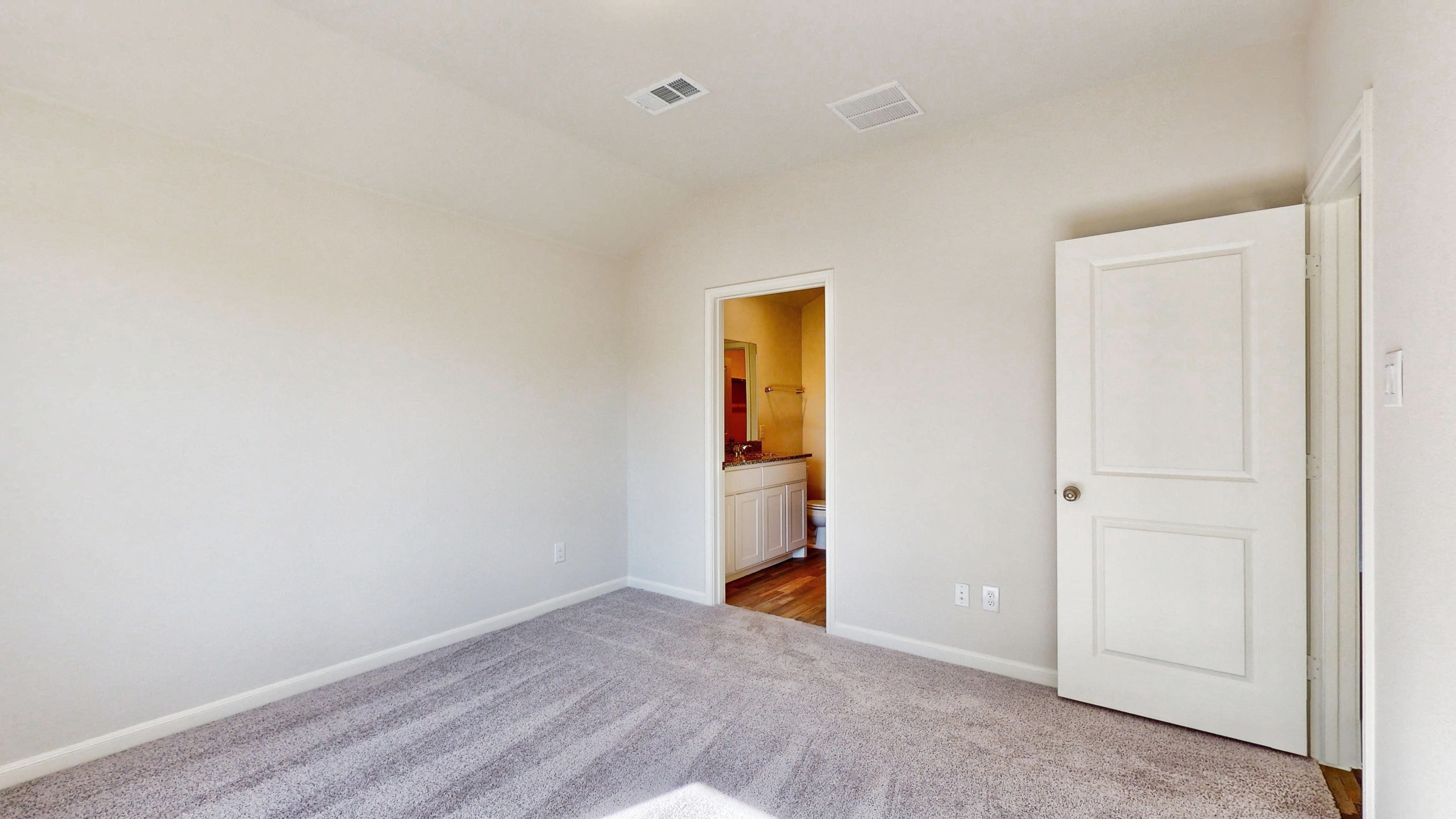 A room with white walls and a carpeted floor.