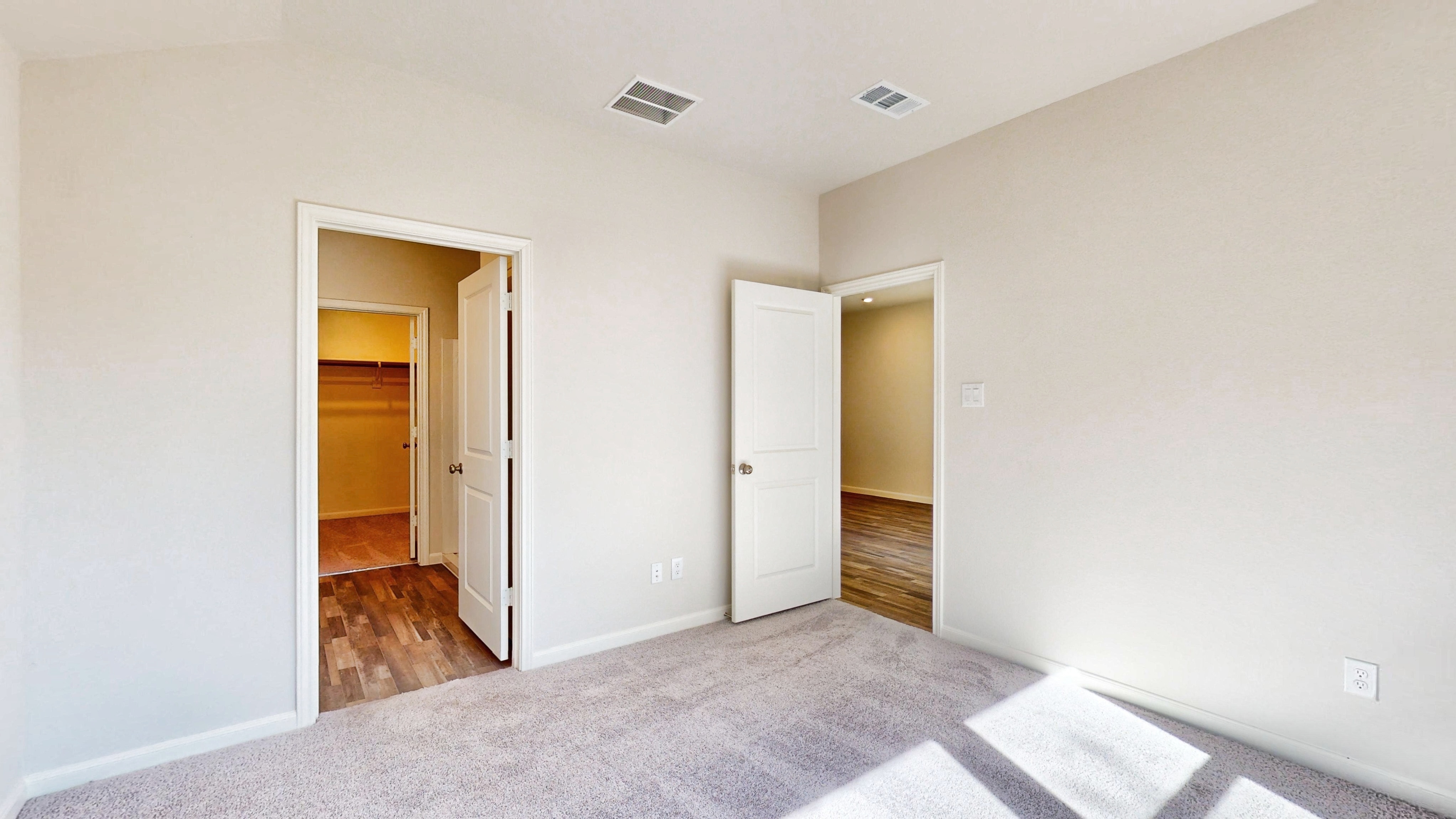 A hallway with white walls.