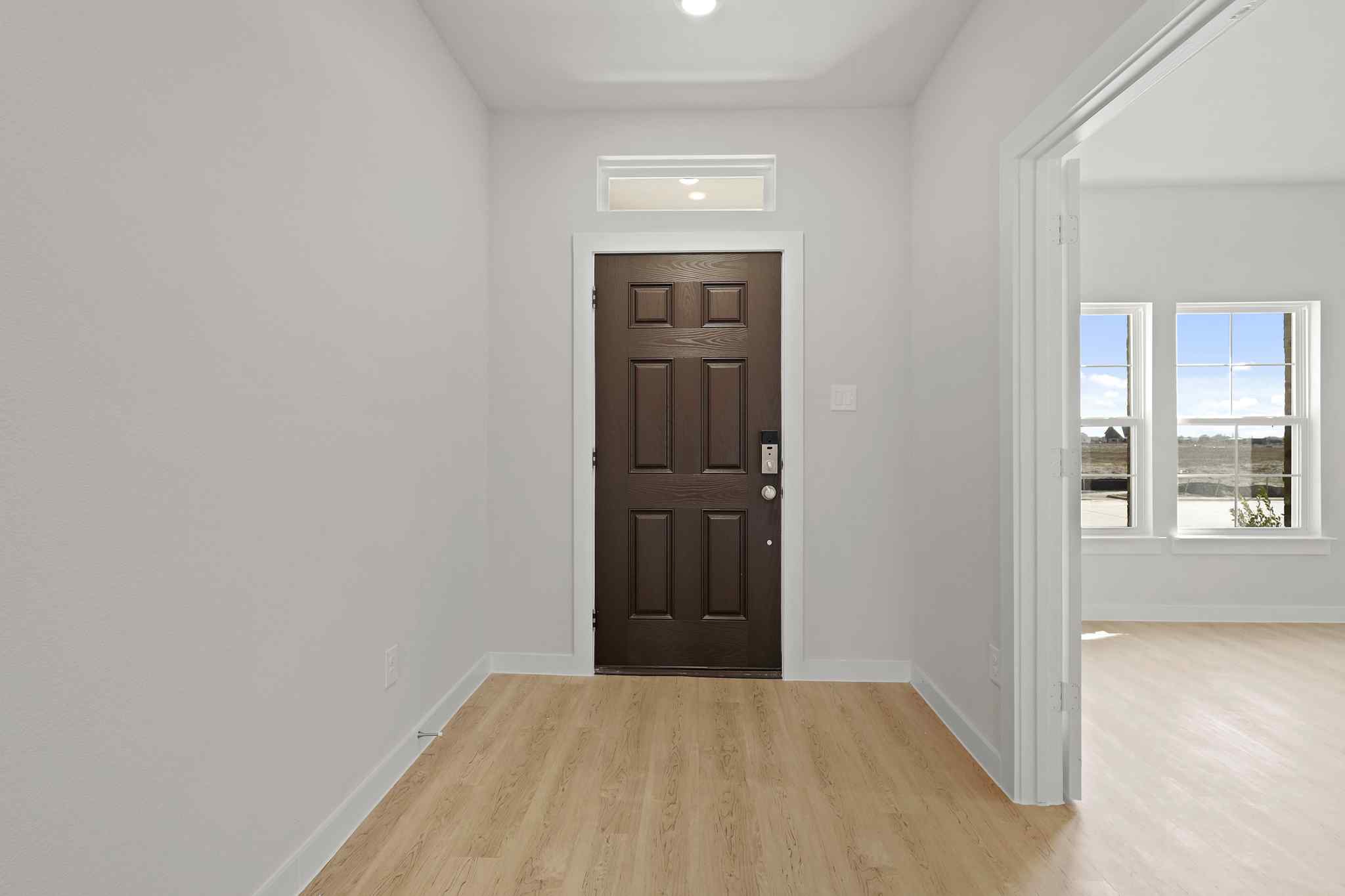 A room with a wood floor and a wood door.