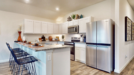 A kitchen with white cabinets.