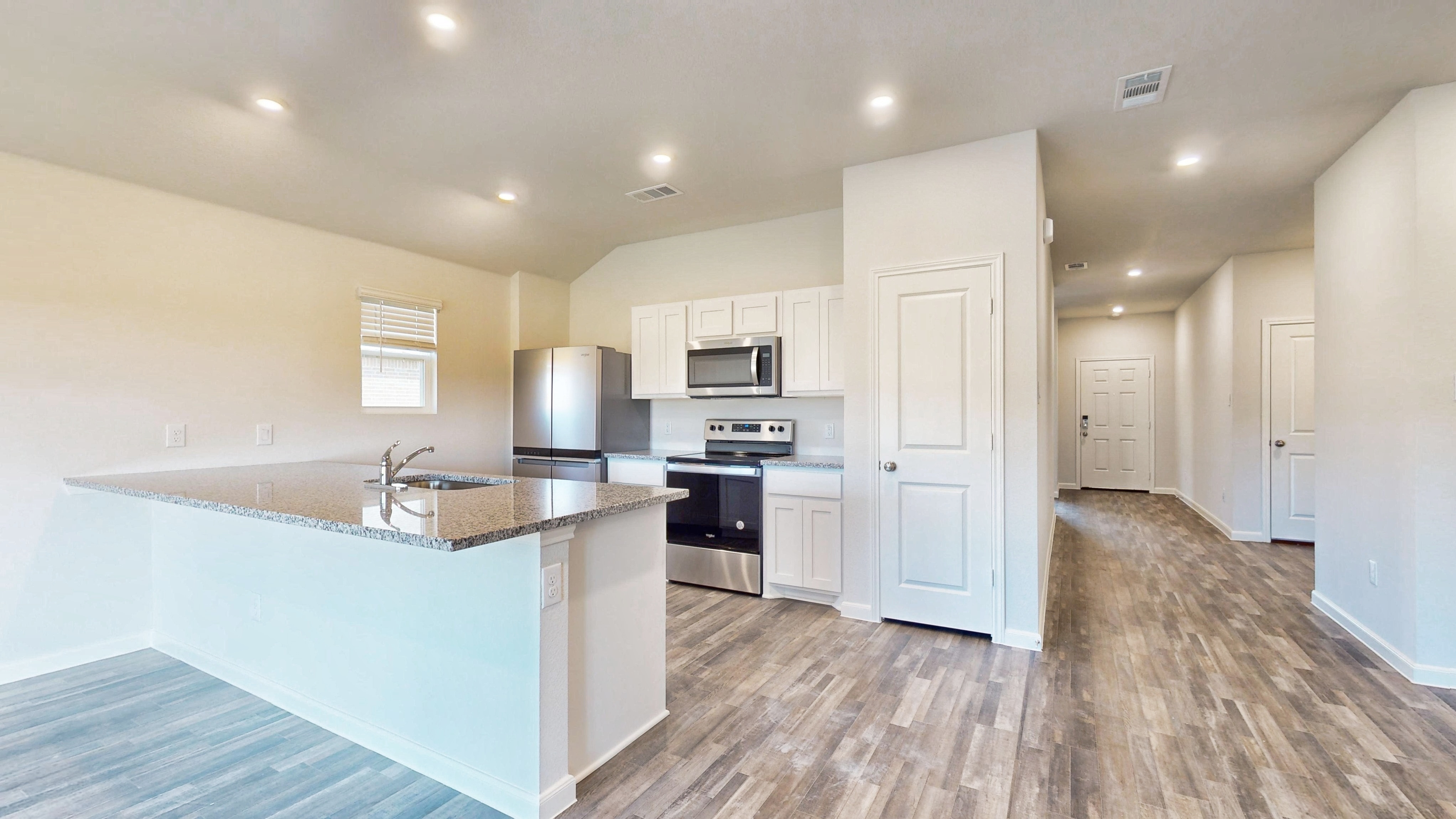 A kitchen with white cabinets.