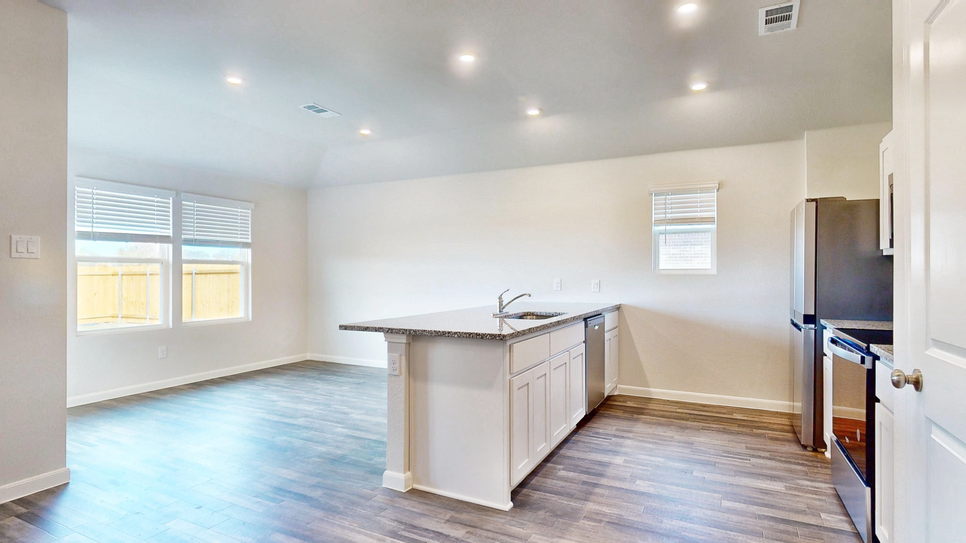 A kitchen with a wood floor.
