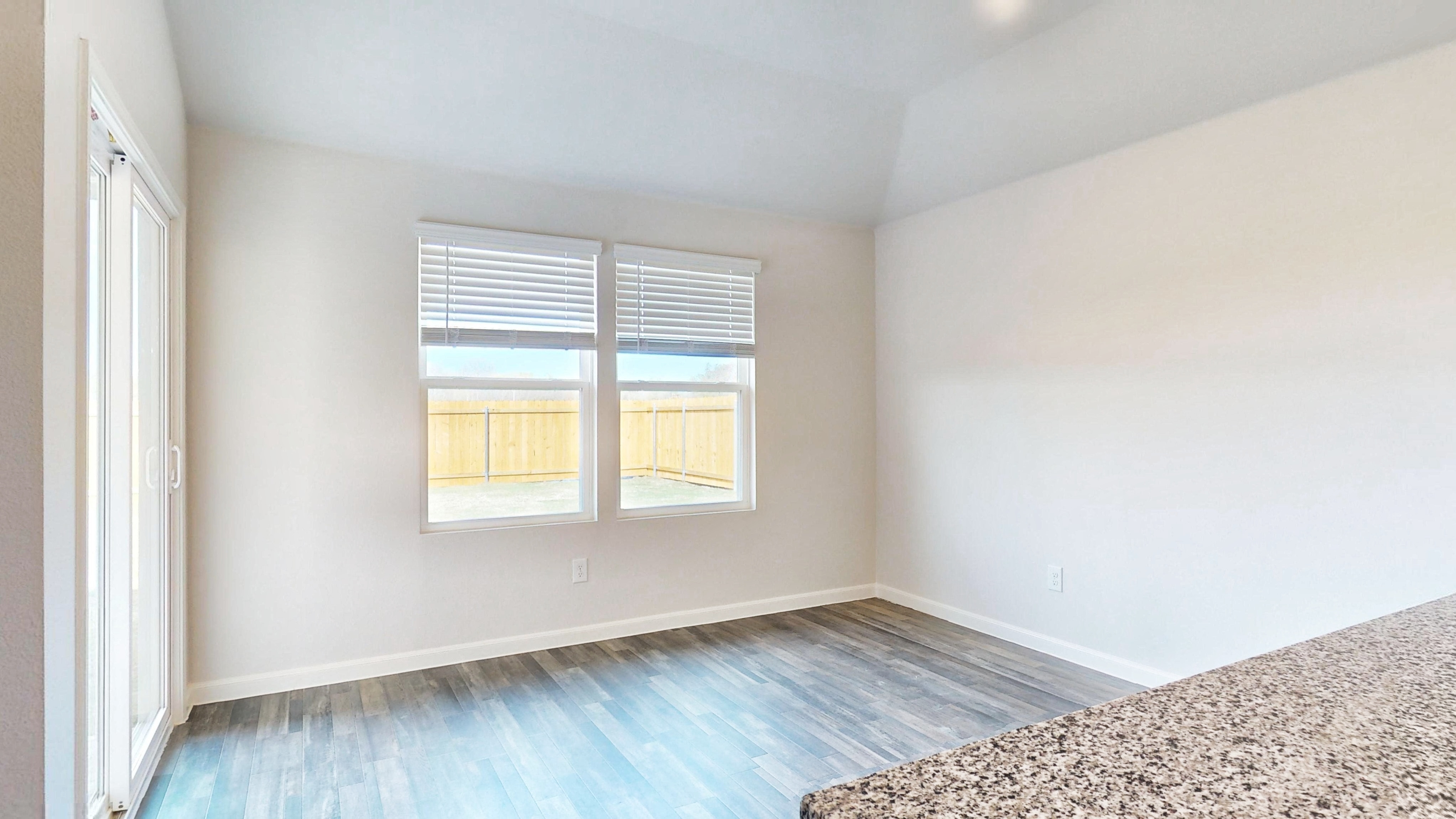 A room with a blue floor and windows.