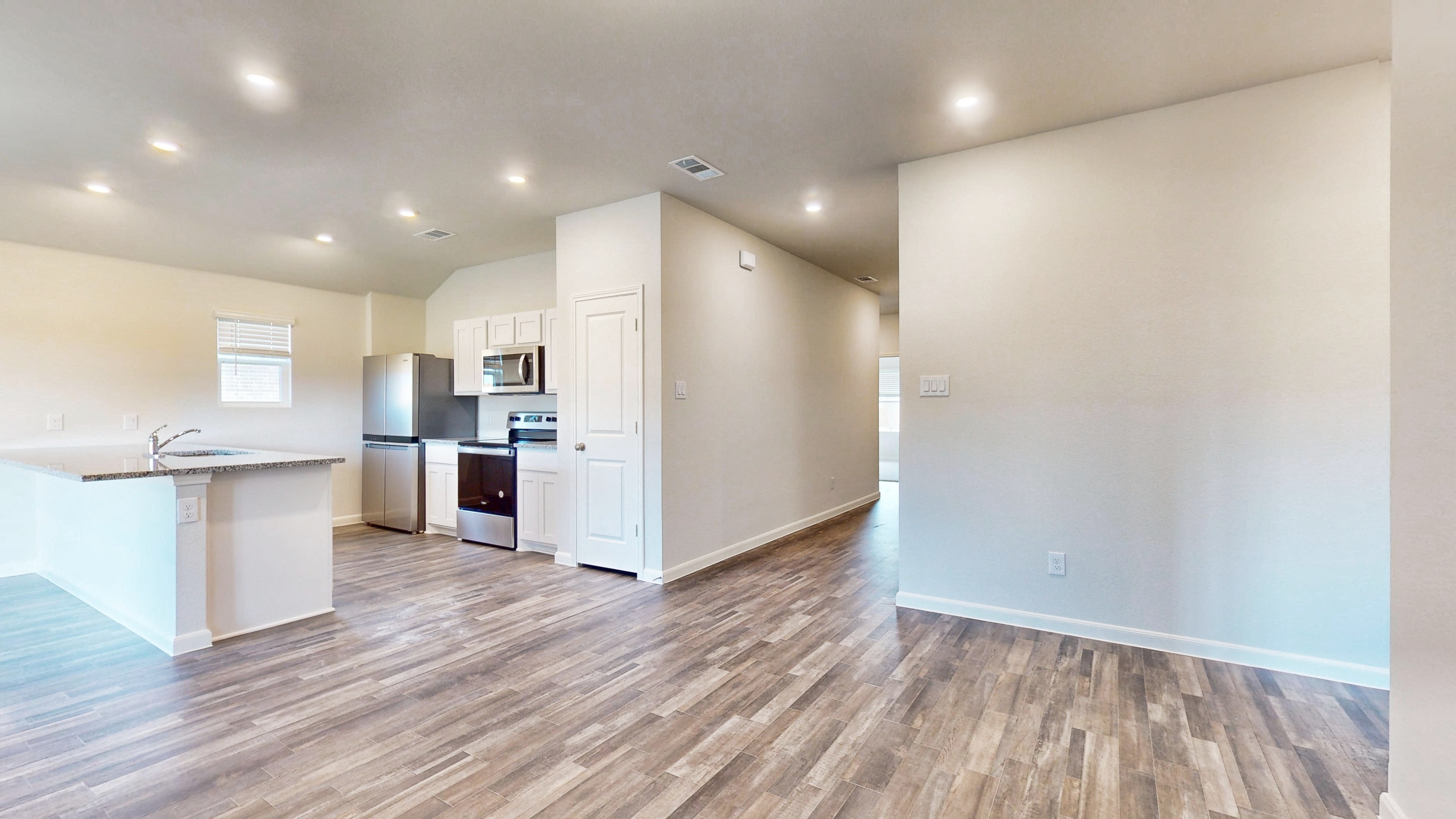 A kitchen with white cabinets.