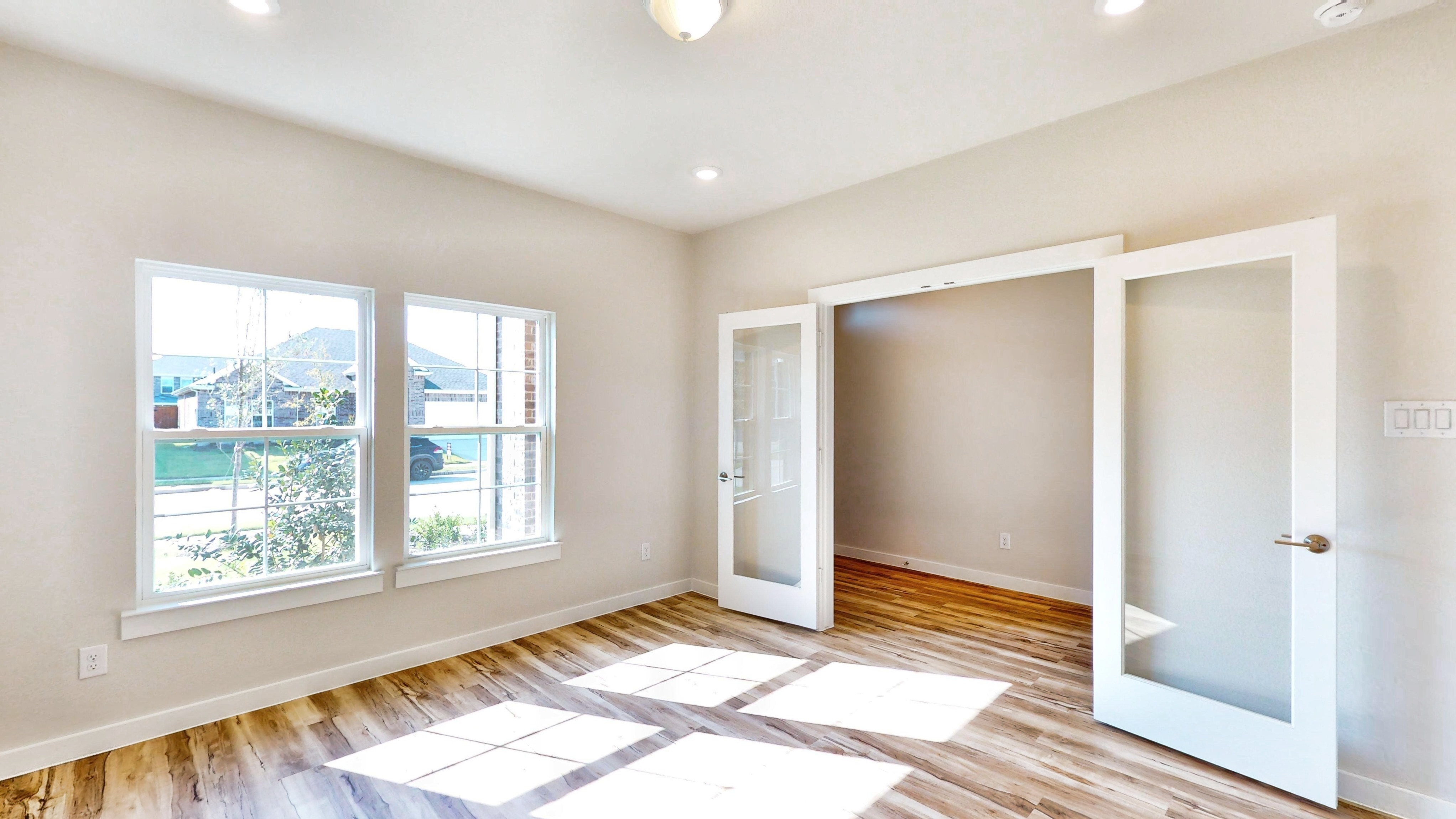 A room with a tile floor and a window with a view of the city.