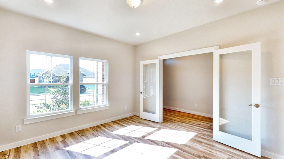 A room with a tile floor and a window with a view of the city.