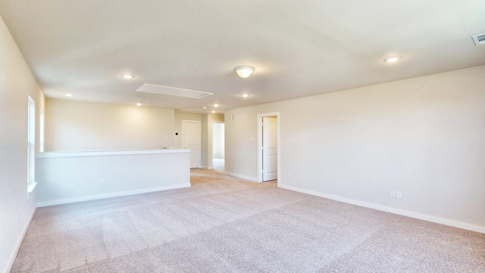 A long hallway with white walls.