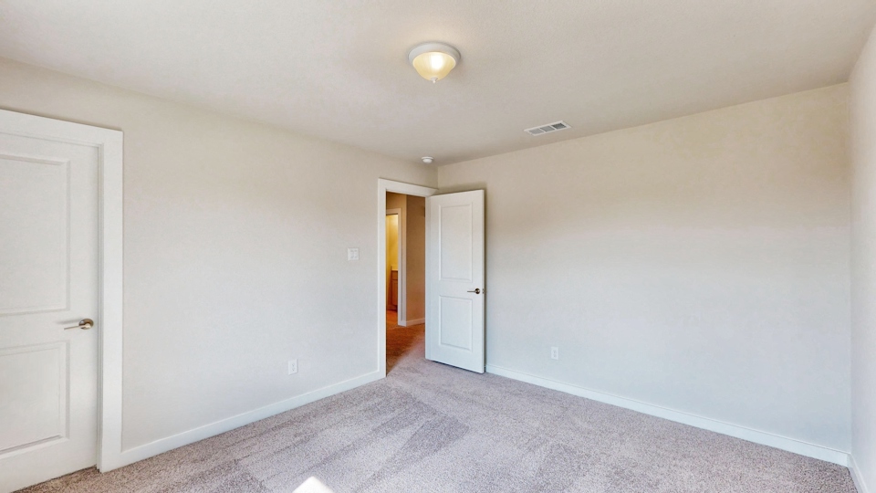 A hallway with white doors.