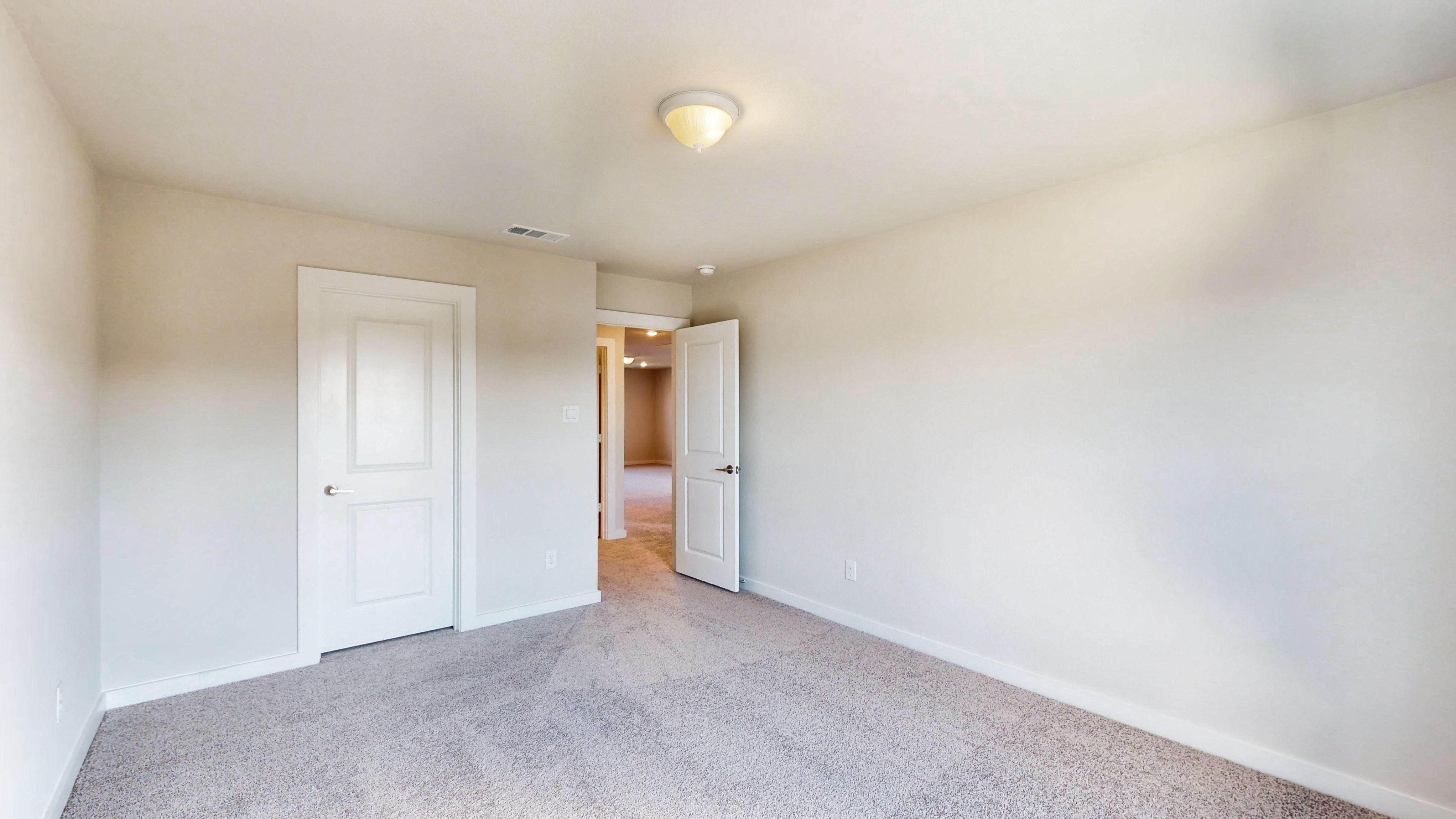 A hallway with white doors.