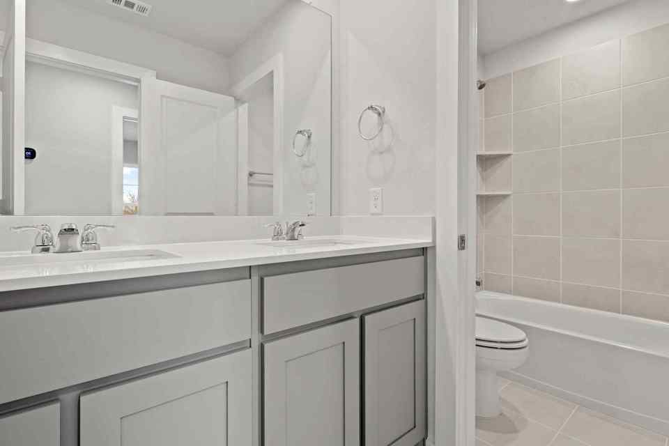 A bathroom with a toilet and sink.