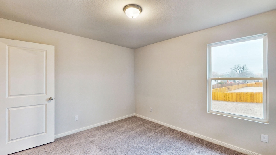 A room with a window and a door.