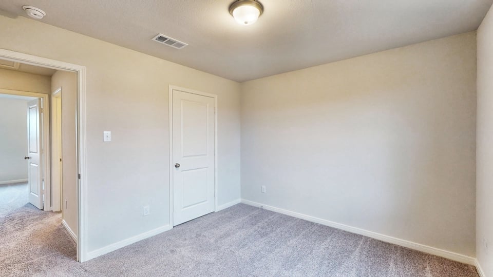 A hallway with white doors.