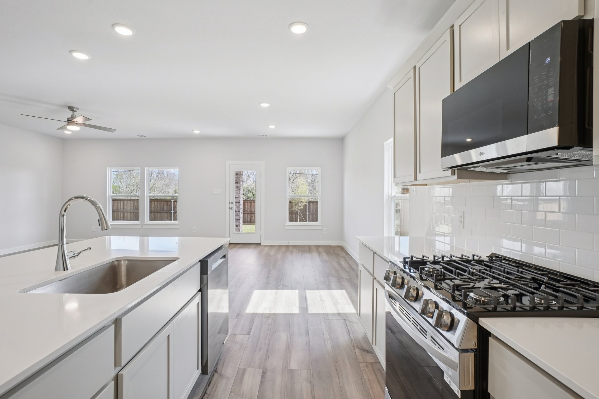 A kitchen with white cabinets.