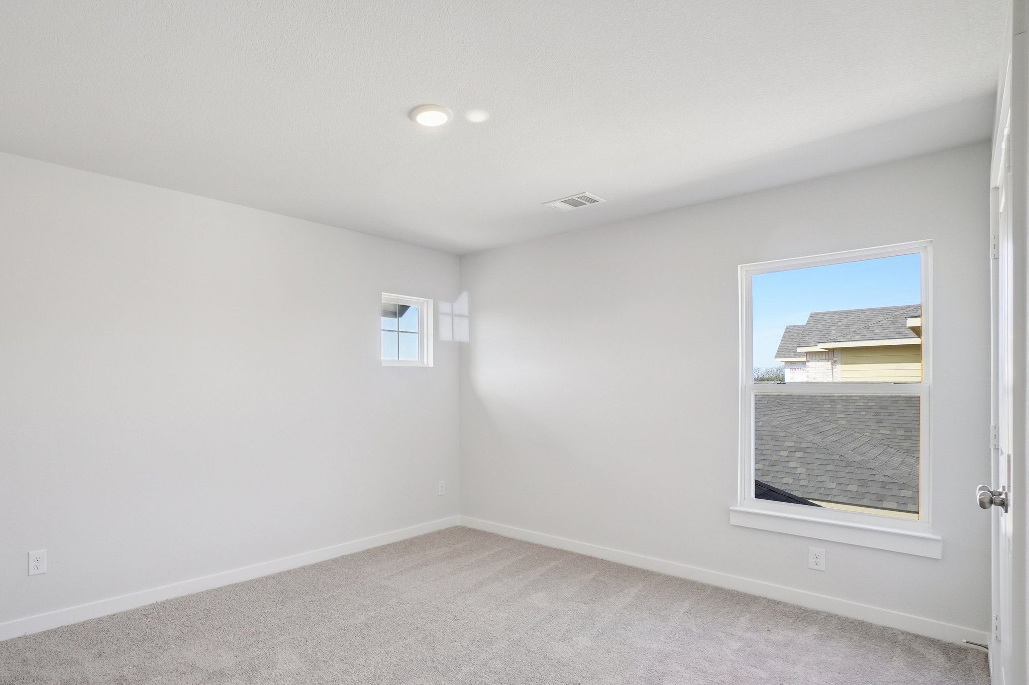 A room with a window and a door.