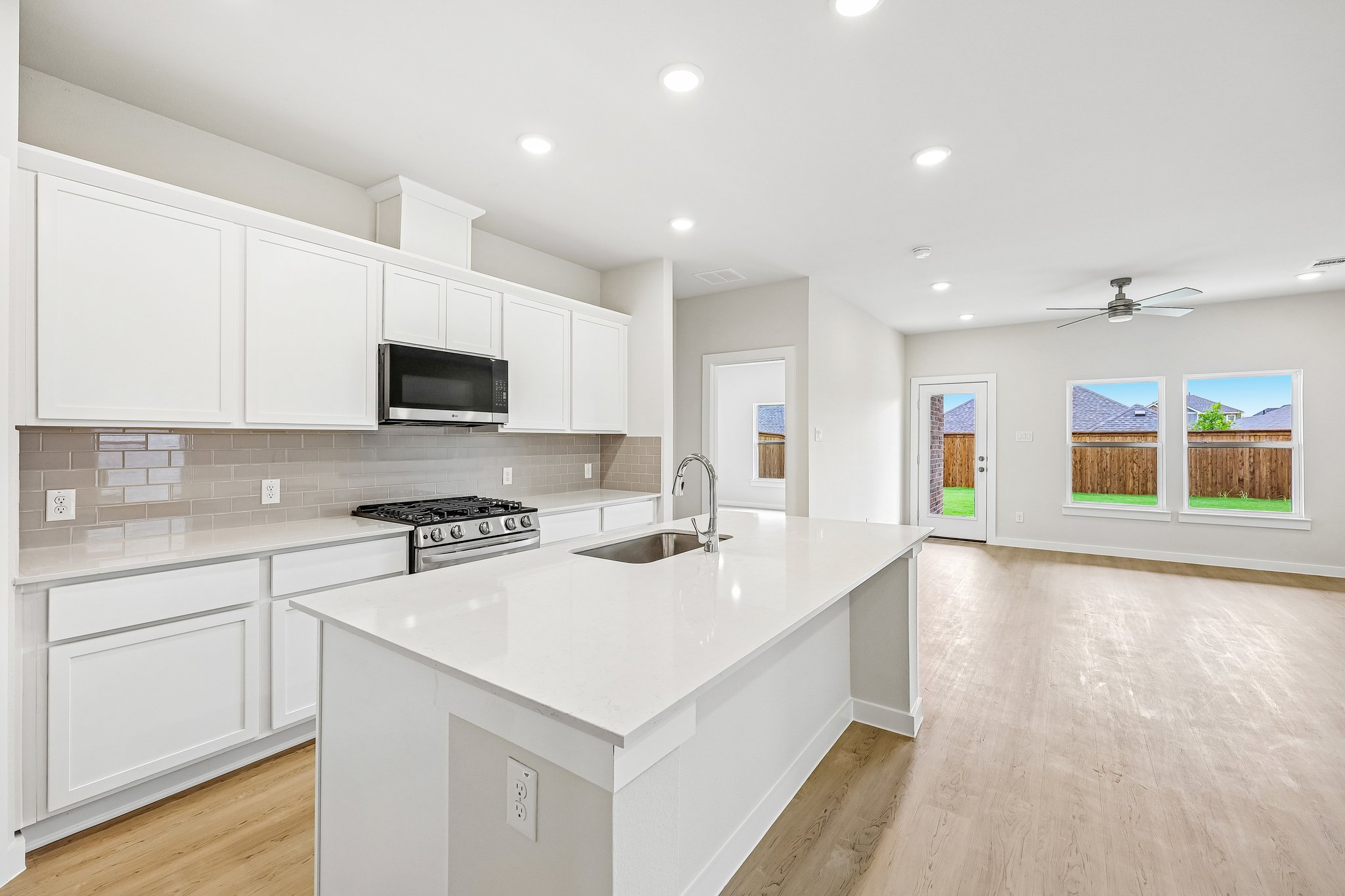 A kitchen with white cabinets.