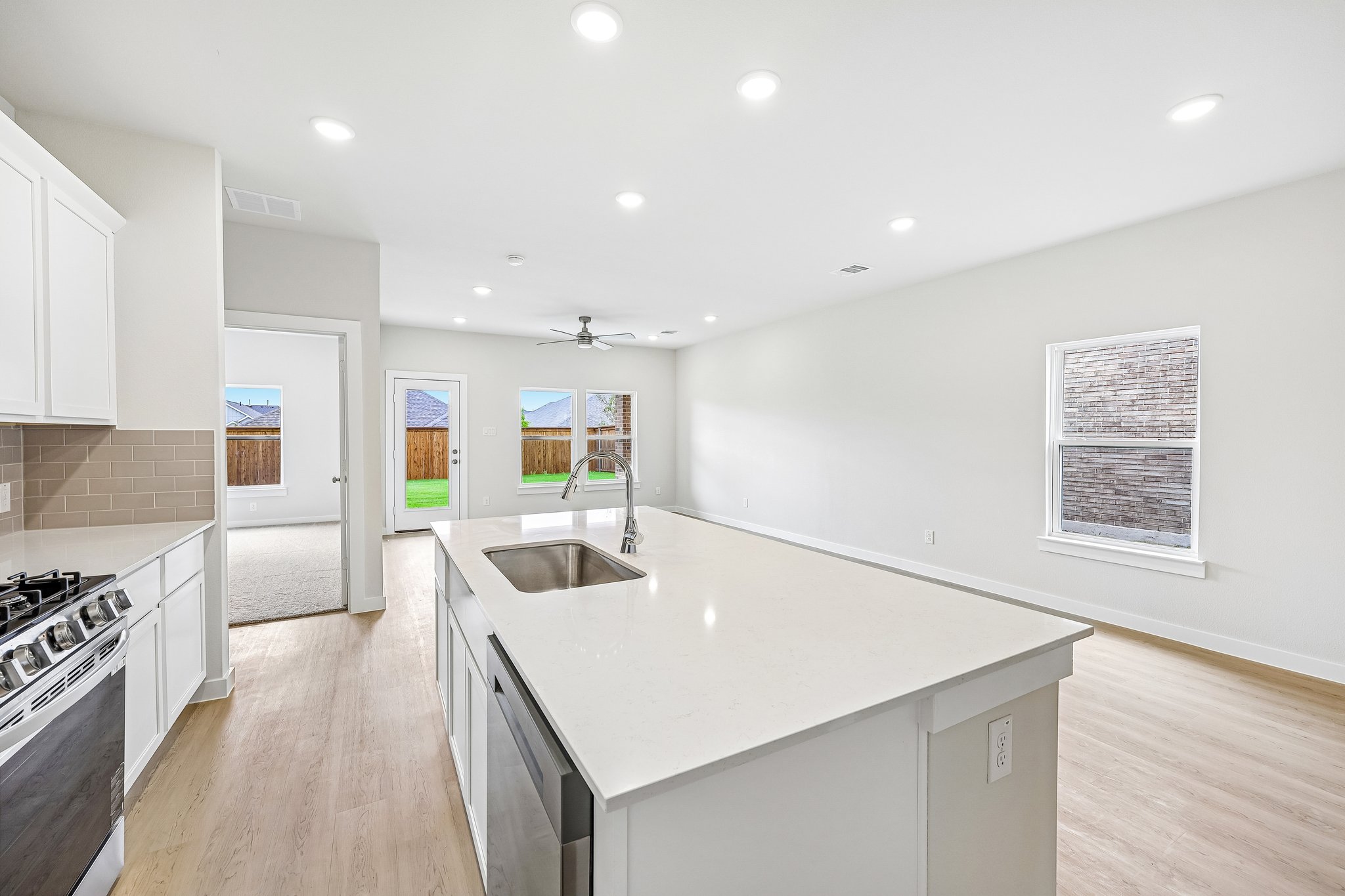 A kitchen with white cabinets.