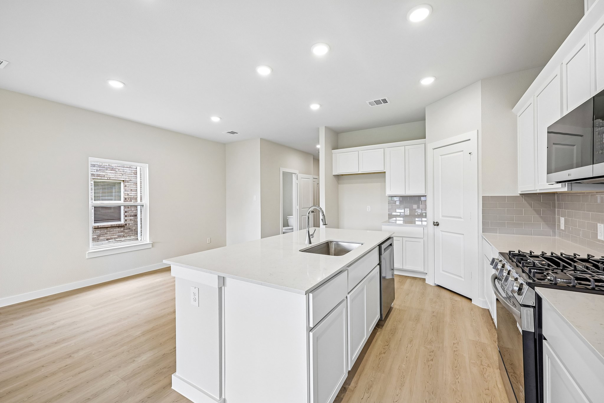 A kitchen with white cabinets.
