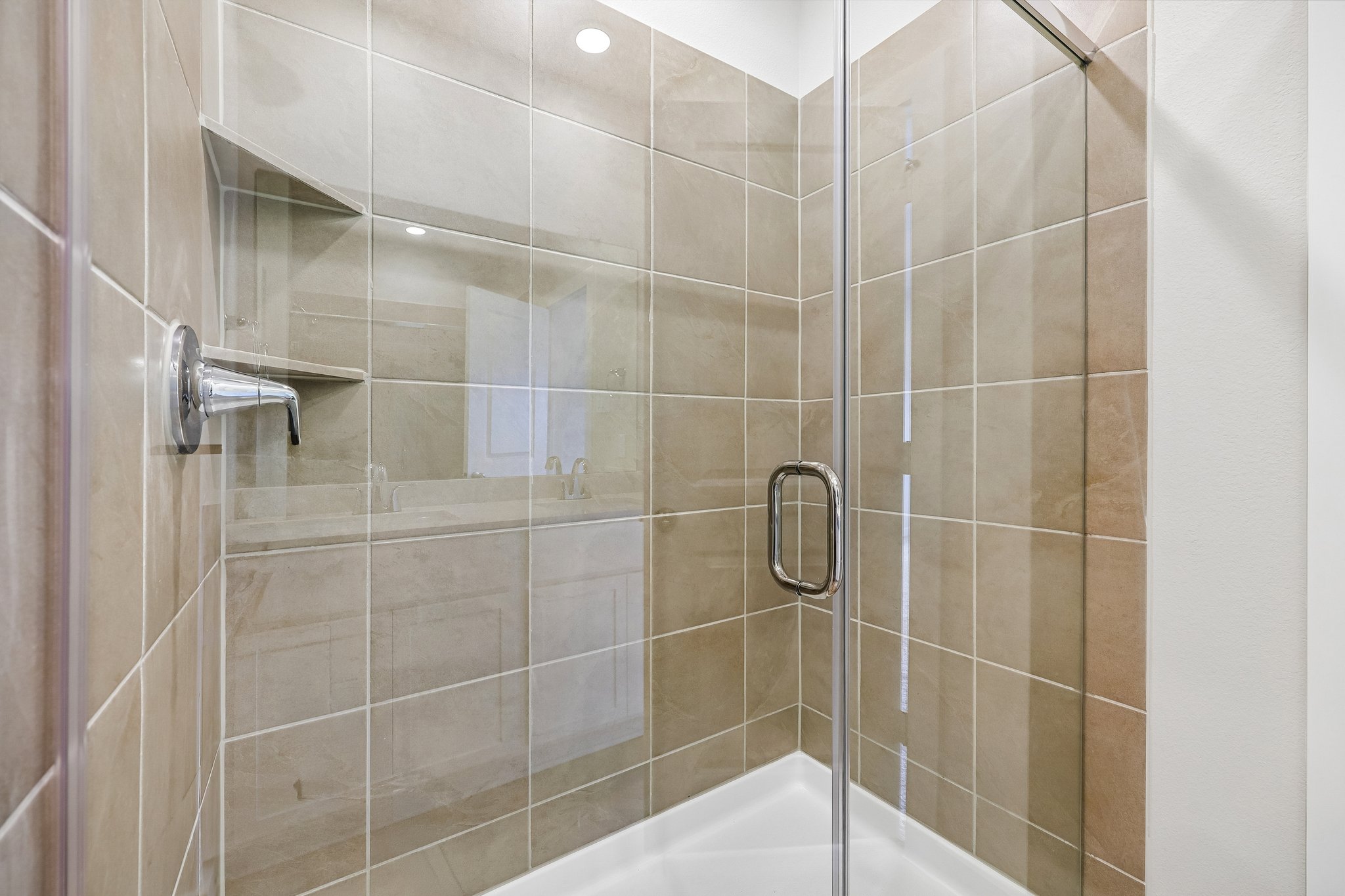 A shower with a glass door.
