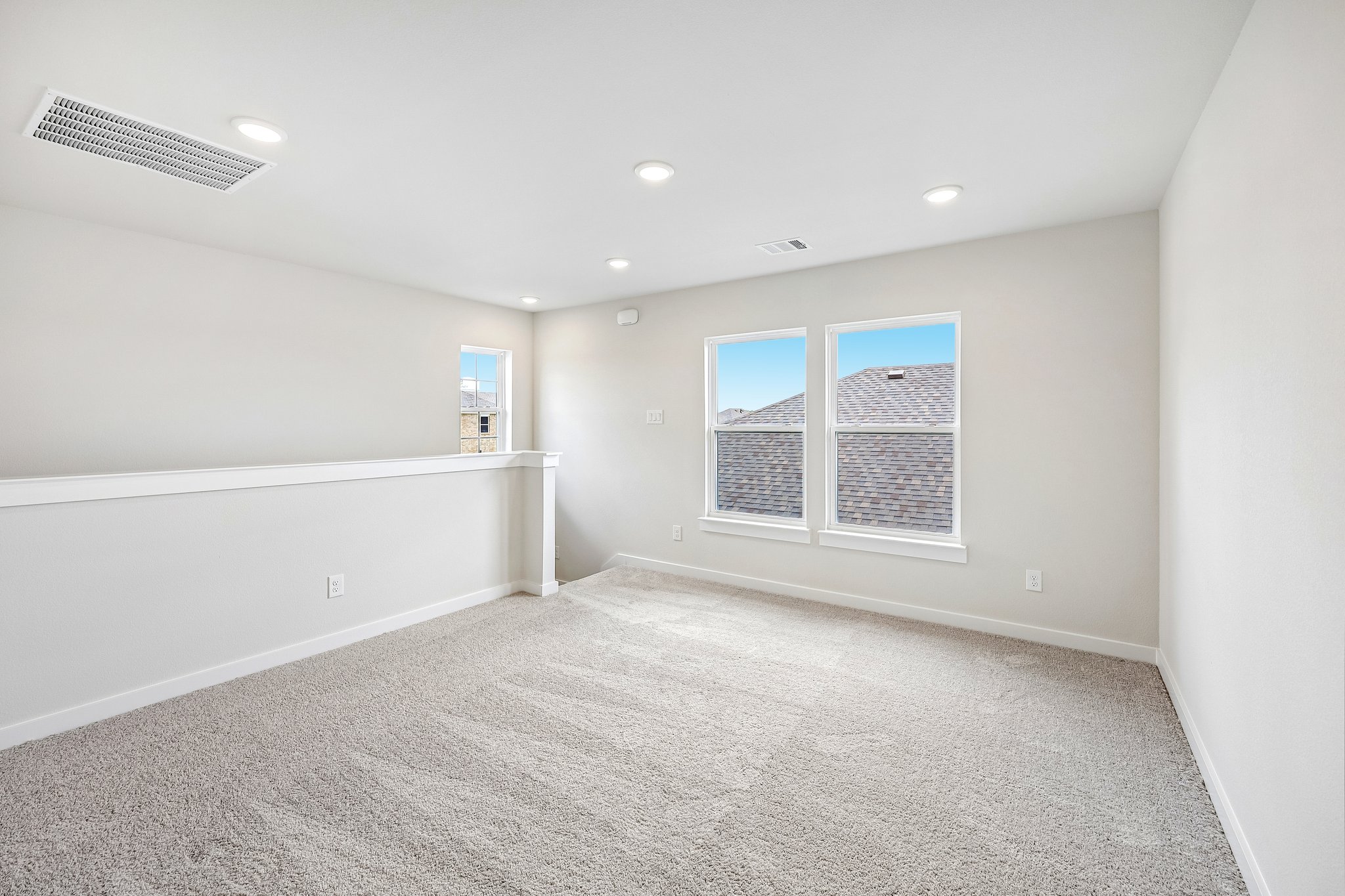 A room with a white wall and a window.