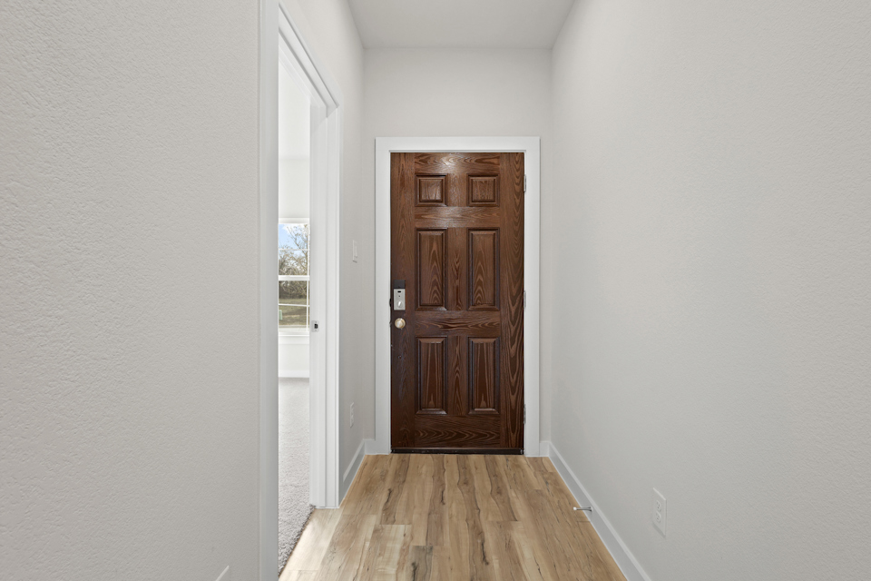 A wooden door in a room.