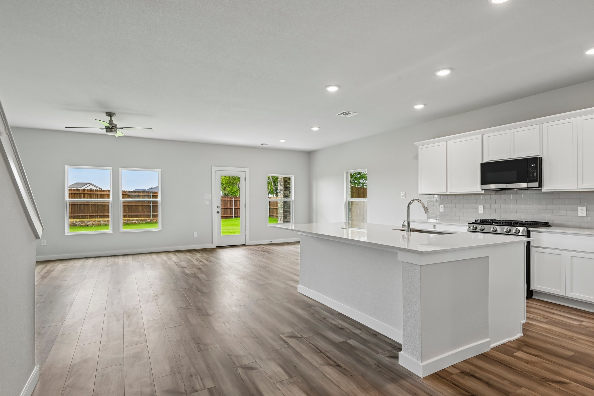 A kitchen with white cabinets.