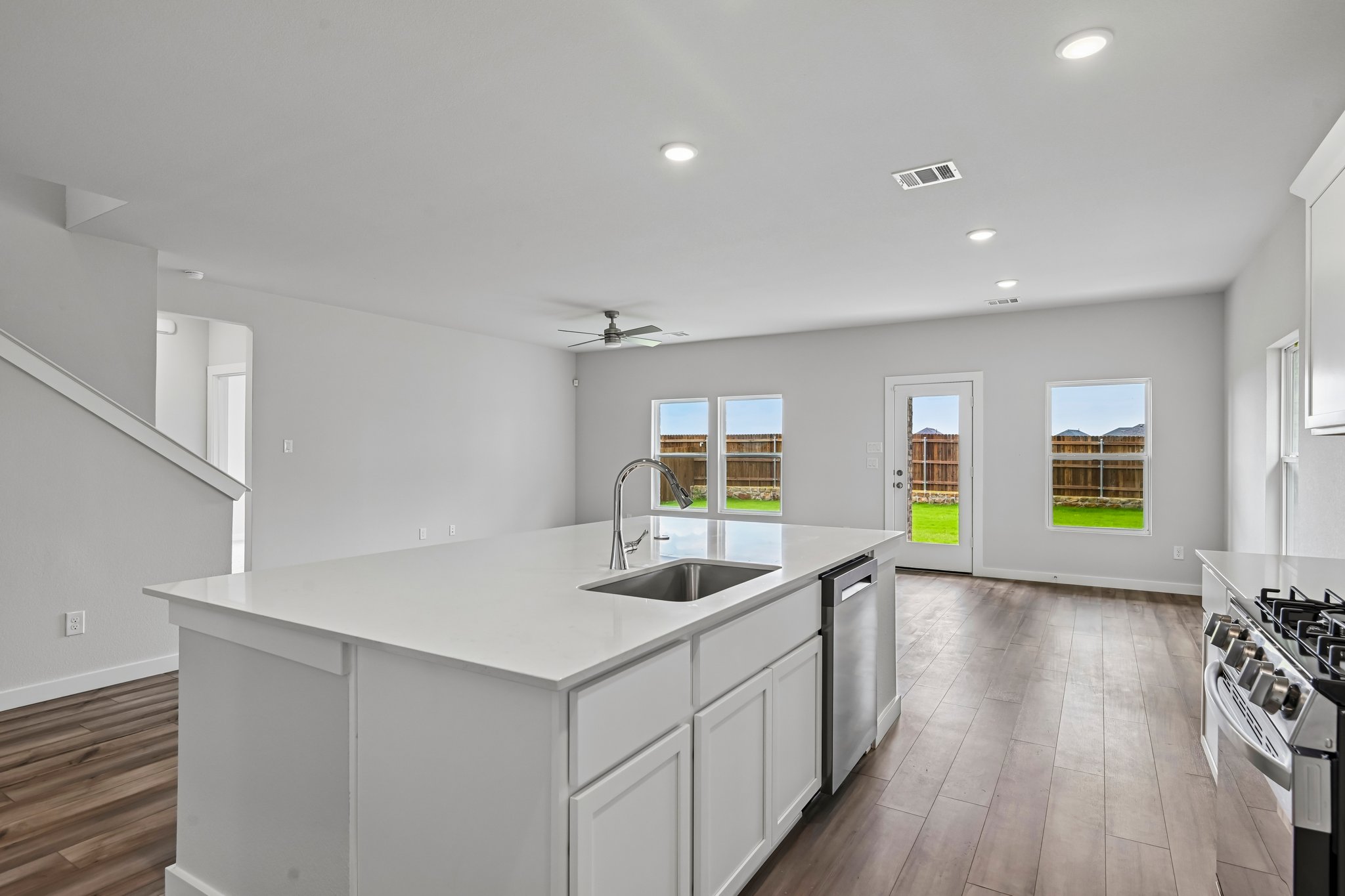A kitchen with white cabinets.