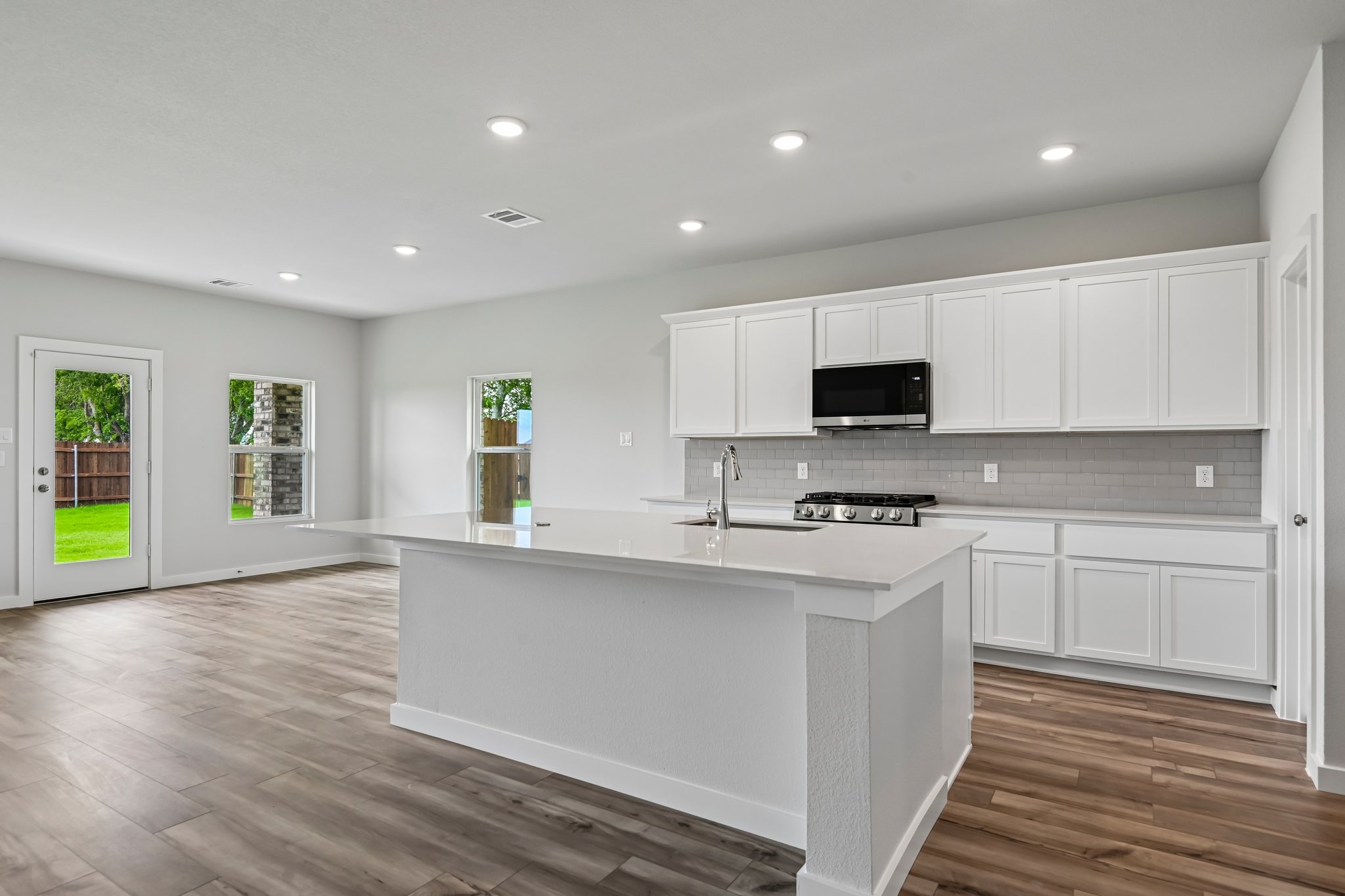 A kitchen with white cabinets.