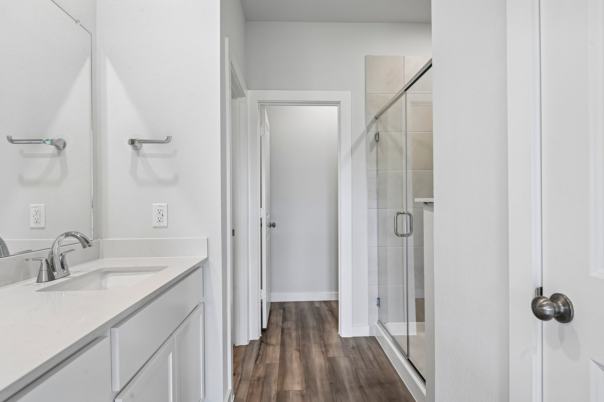 A bathroom with a glass shower.