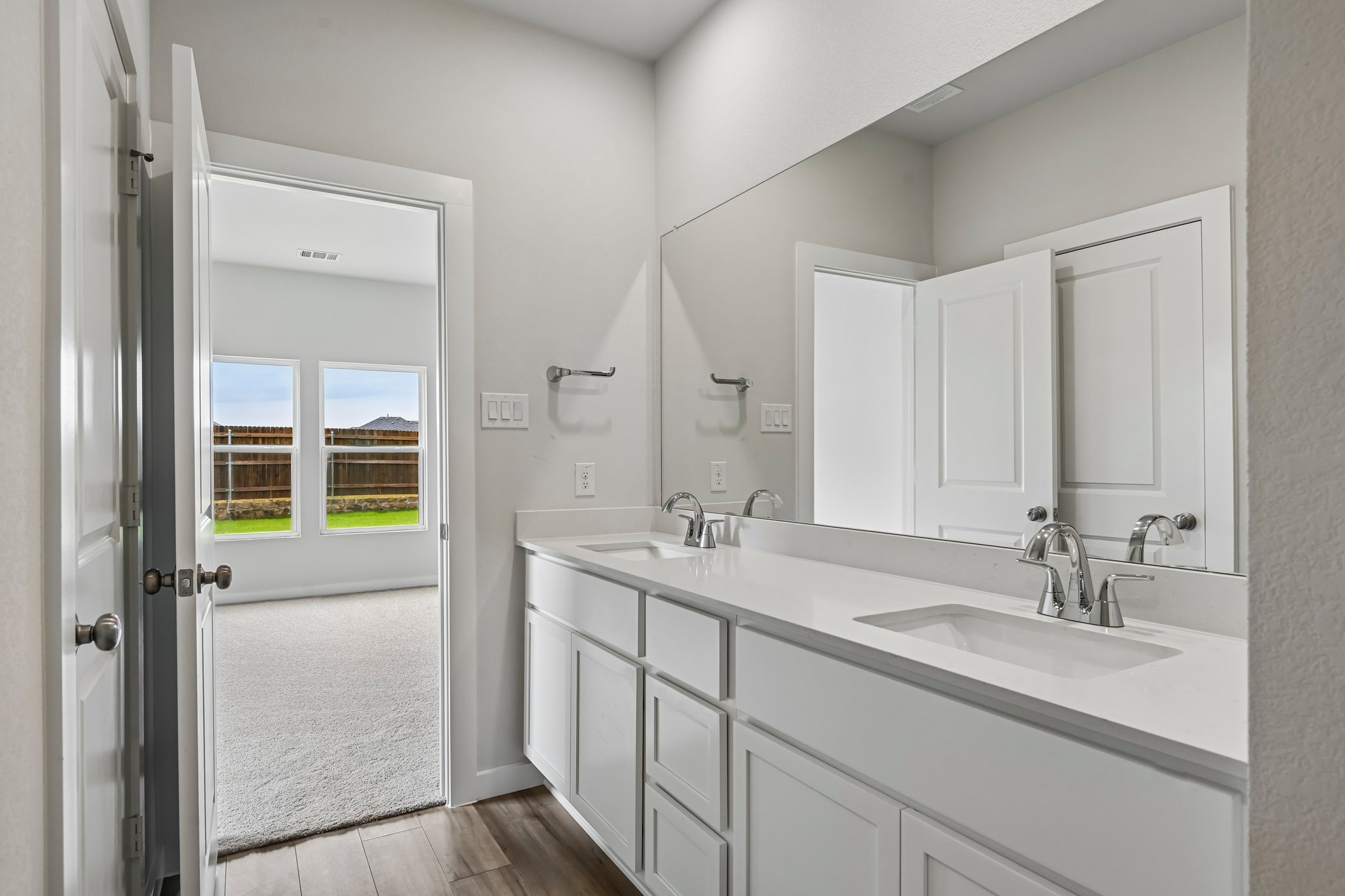 A bathroom with a sink and a shower.