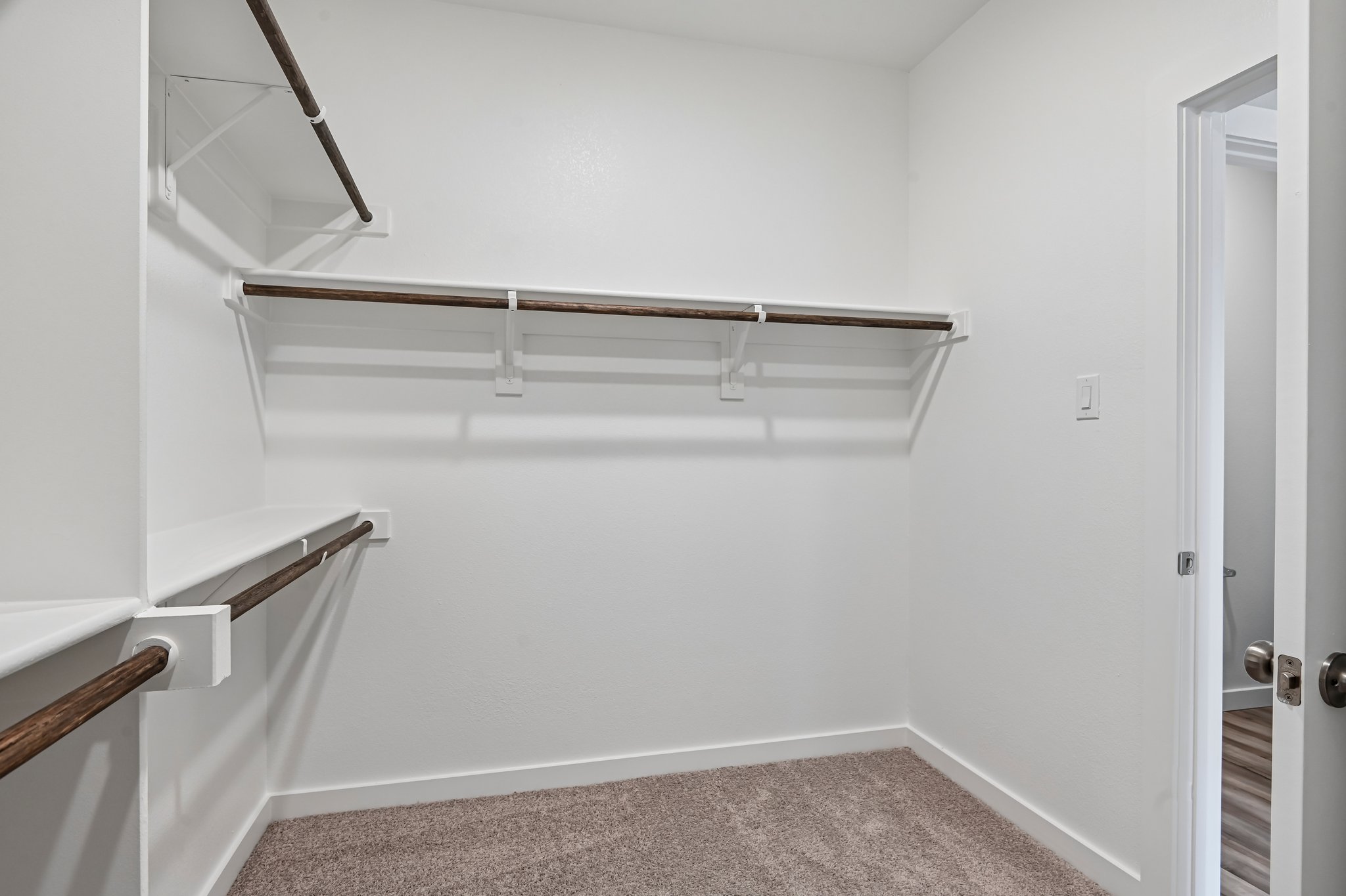 A white room with a metal bar.