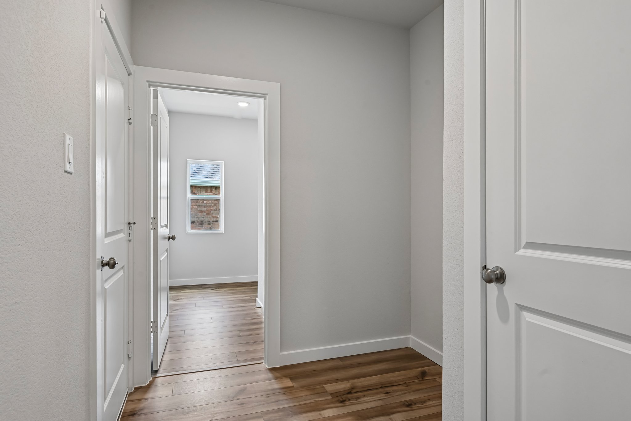 A hallway with white doors.