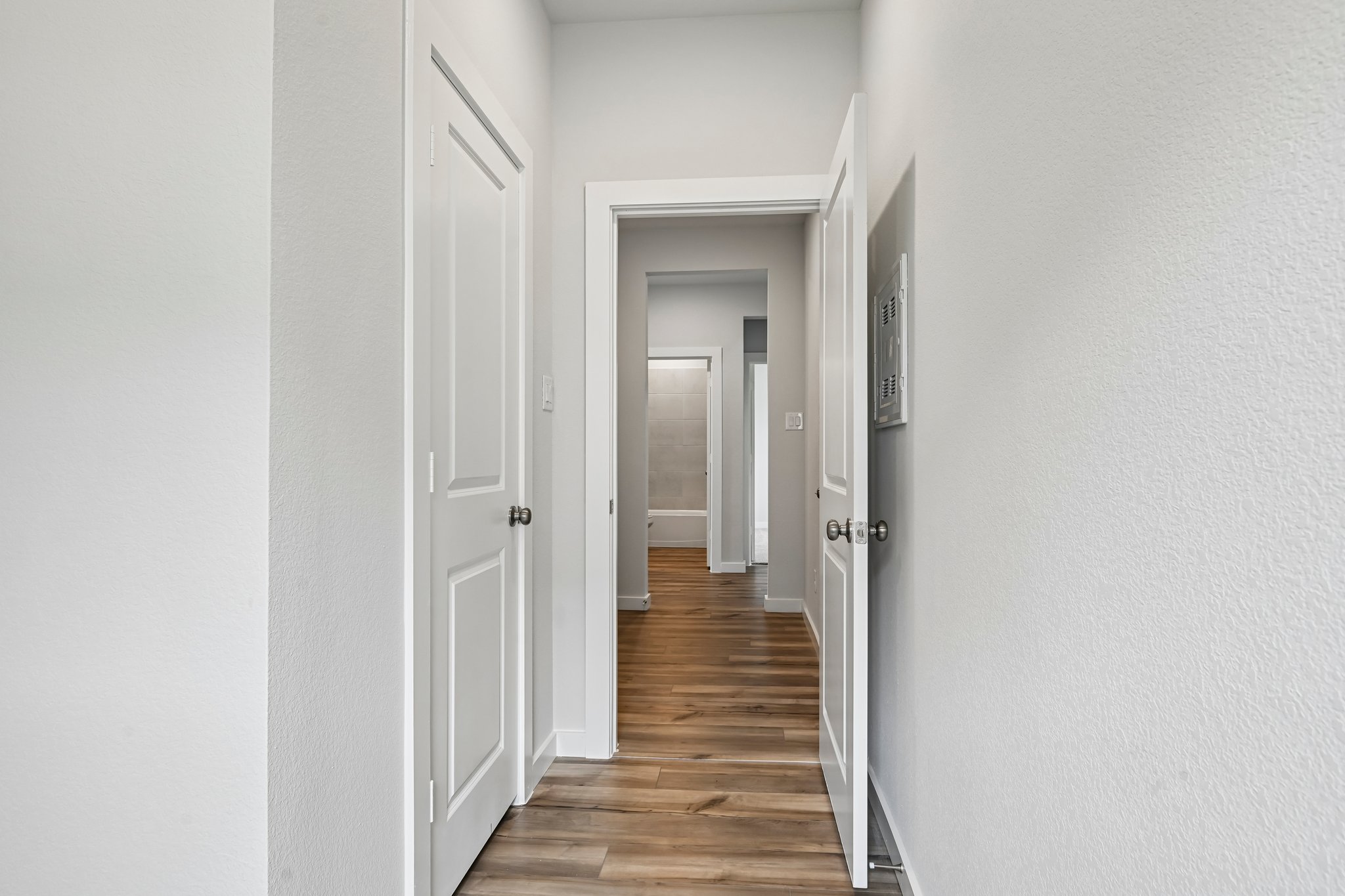 A hallway with white doors.