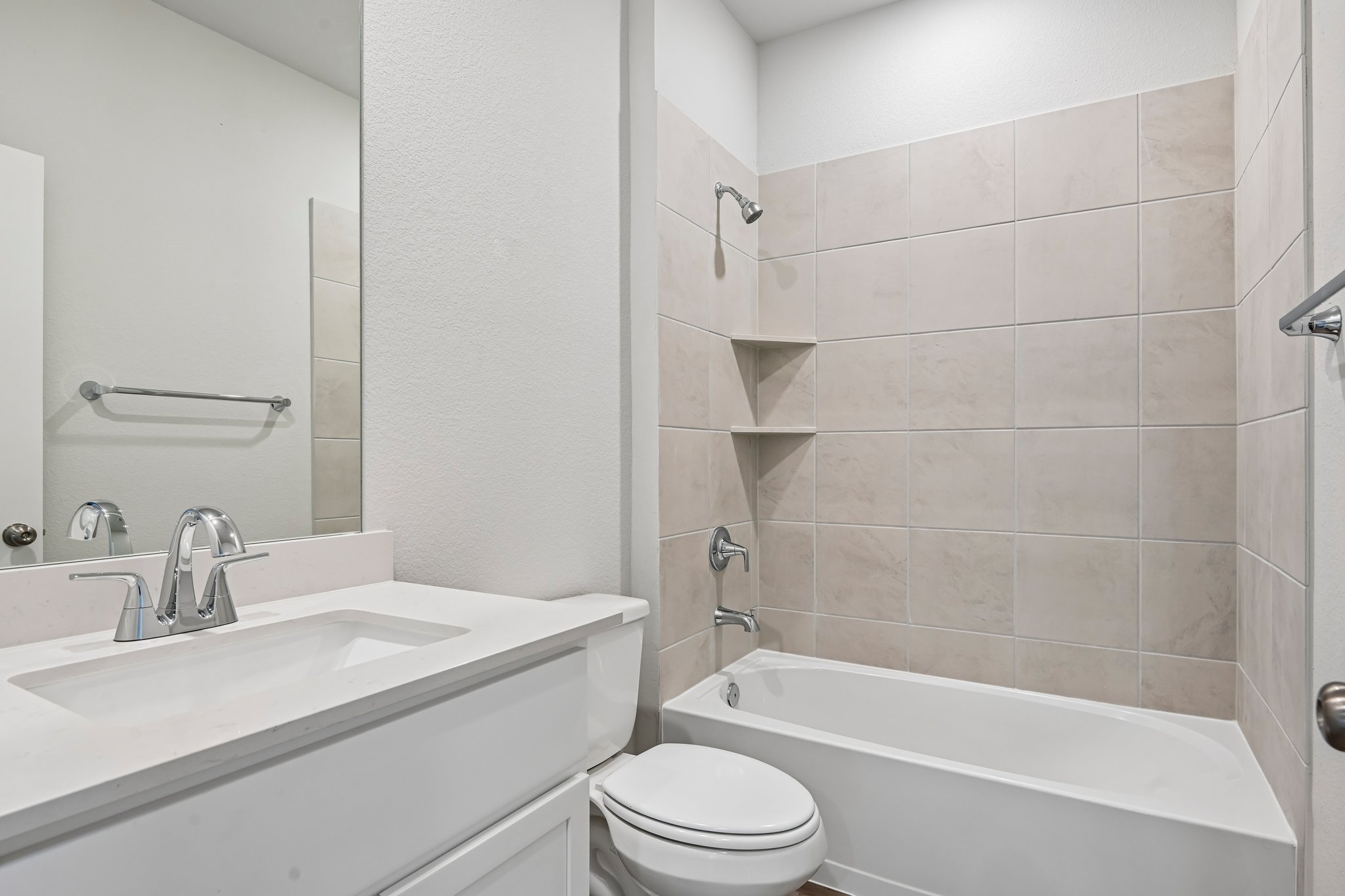 A bathroom with a tub sink and toilet.