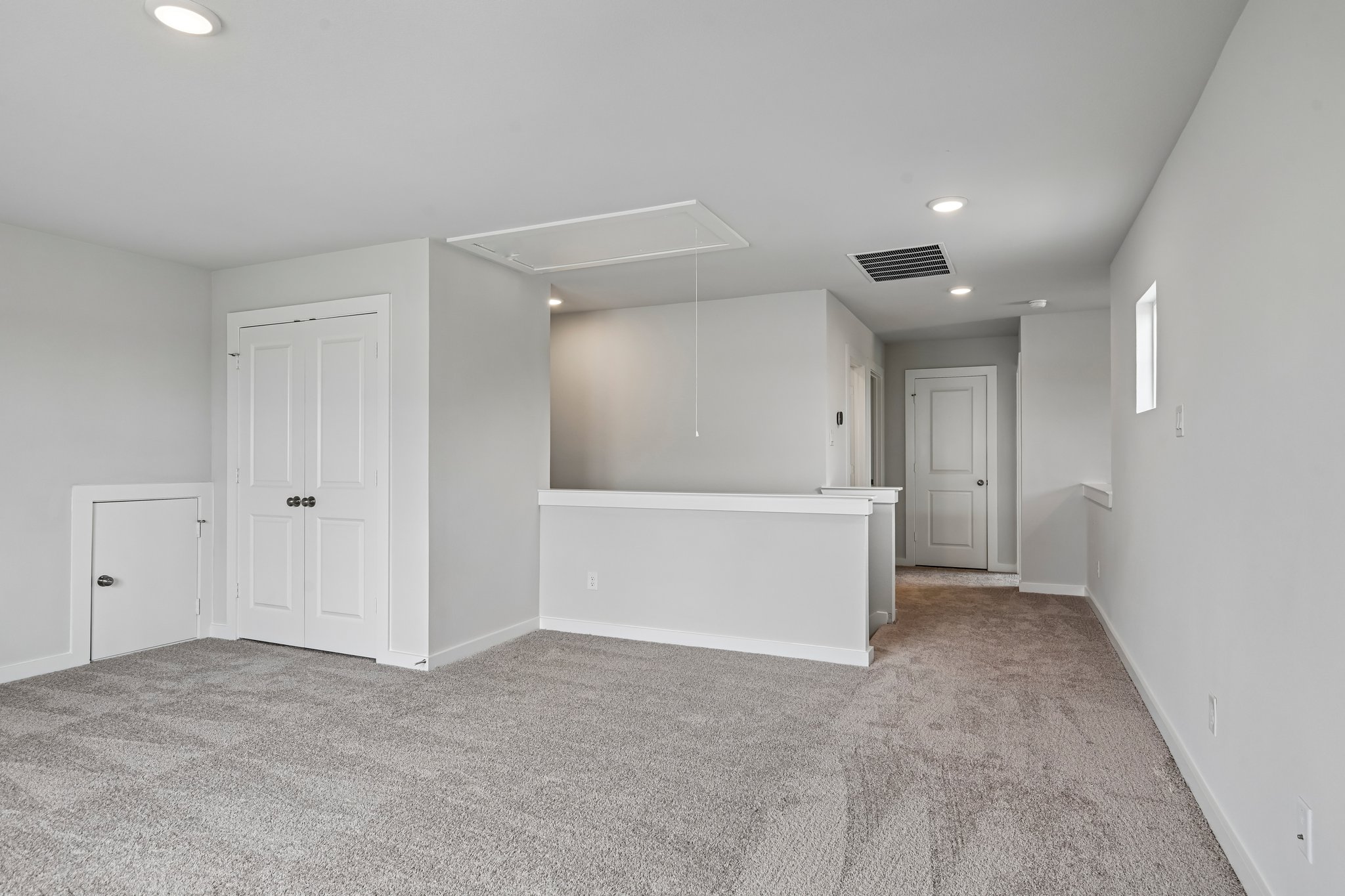 A room with white walls and a white bed.