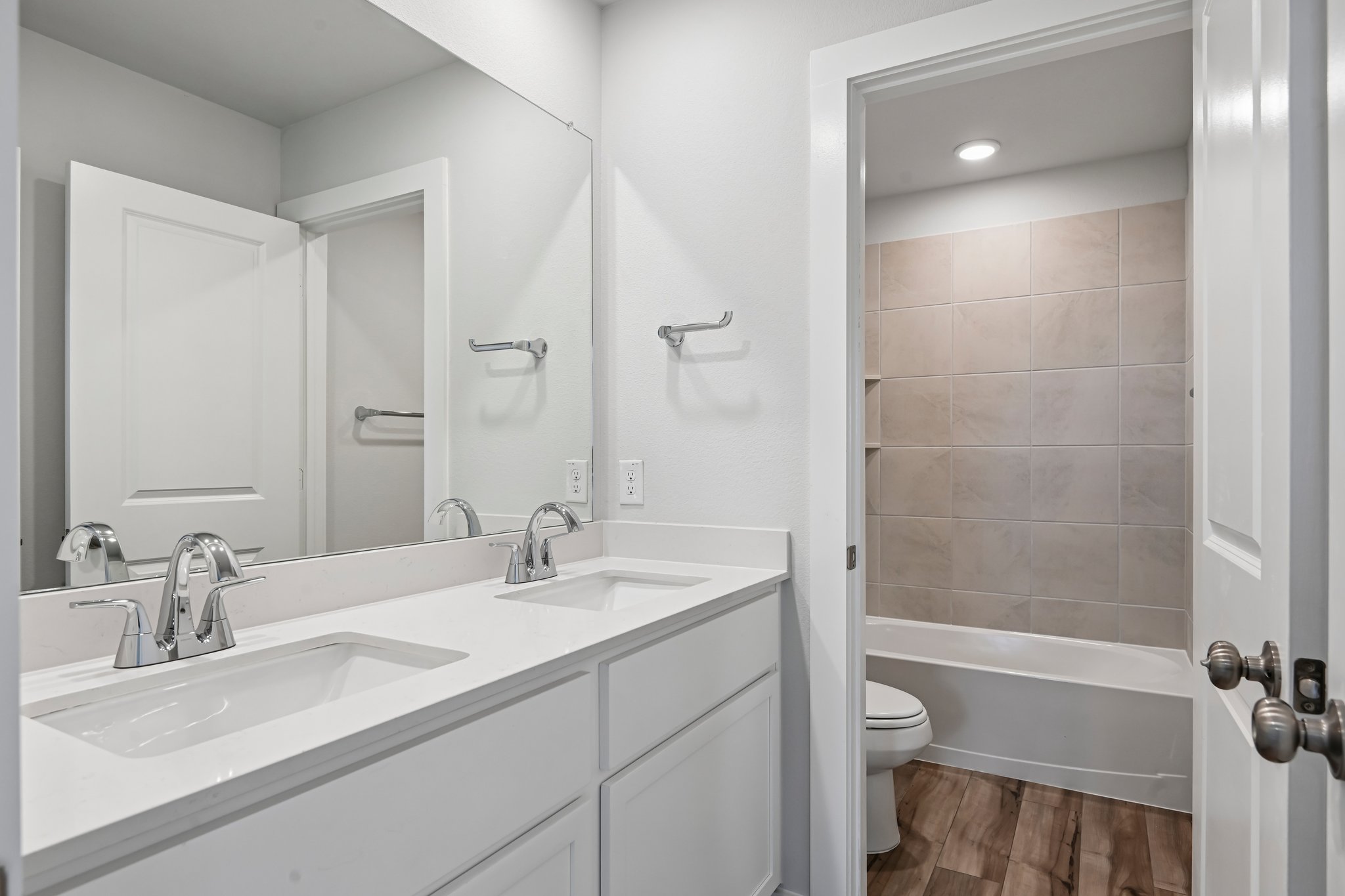 A bathroom with a tub sink and toilet.